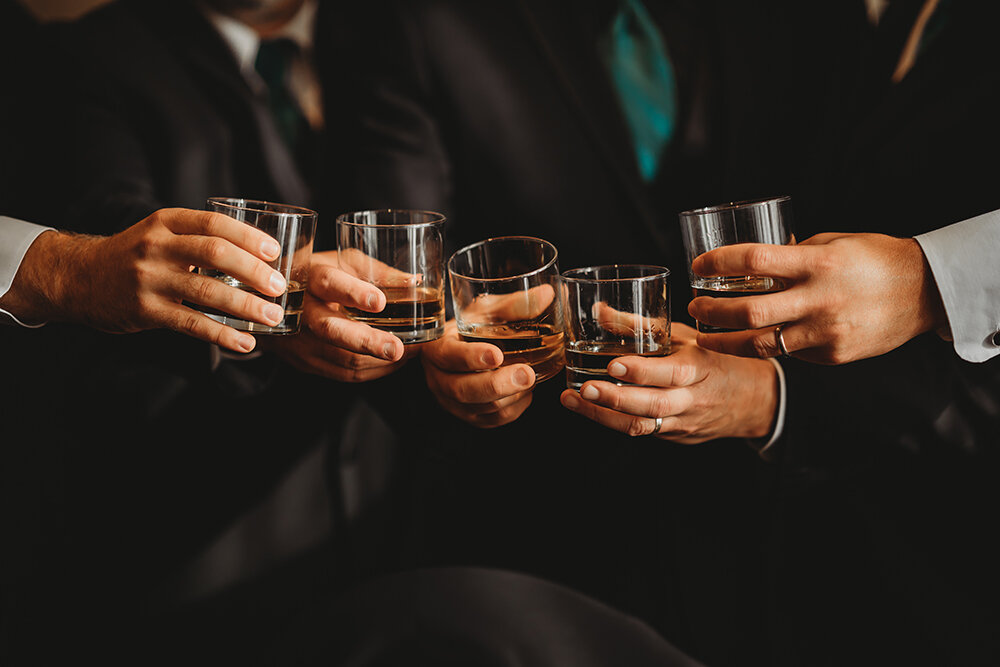 groomsmen cheering over drinks 