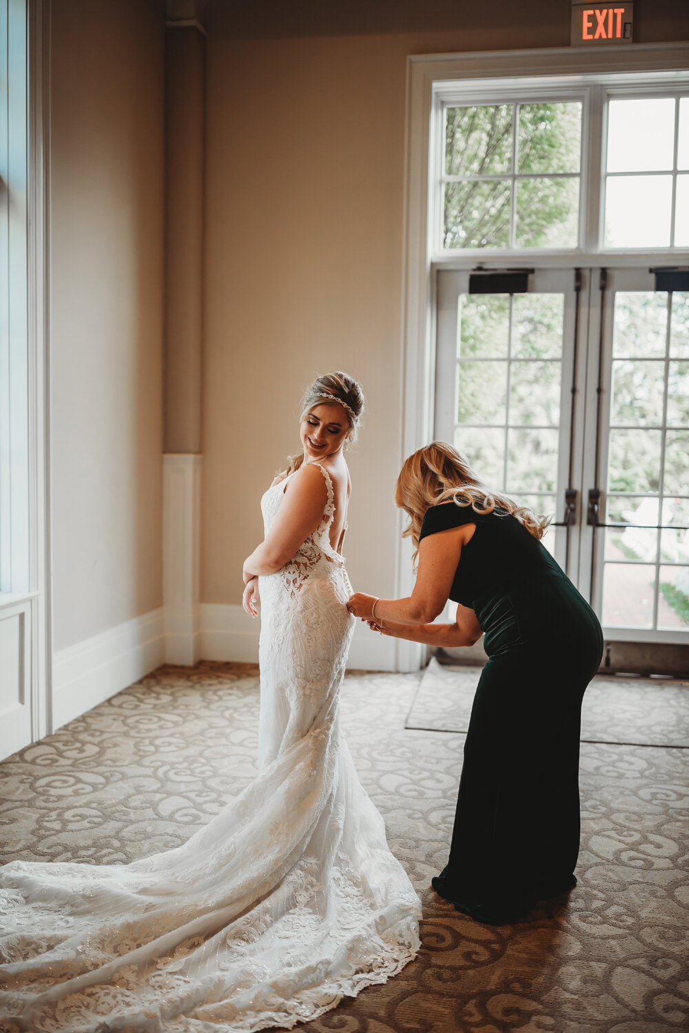 bride putting on her dress 