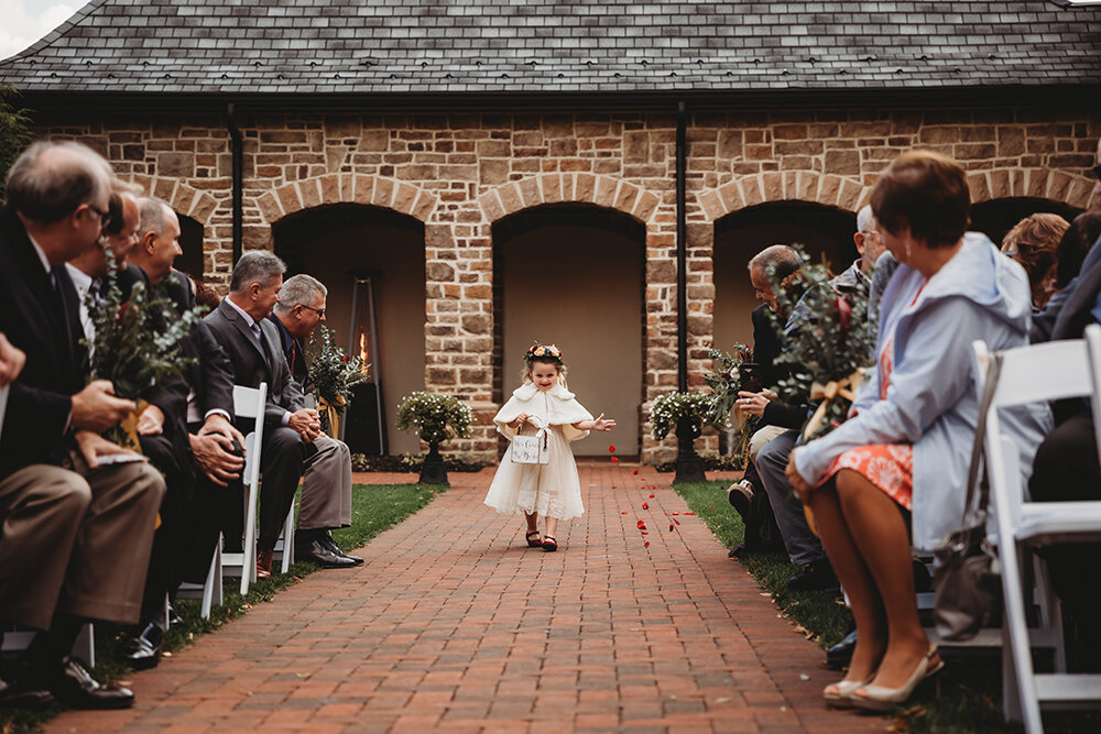 flower girl walking down the aisle