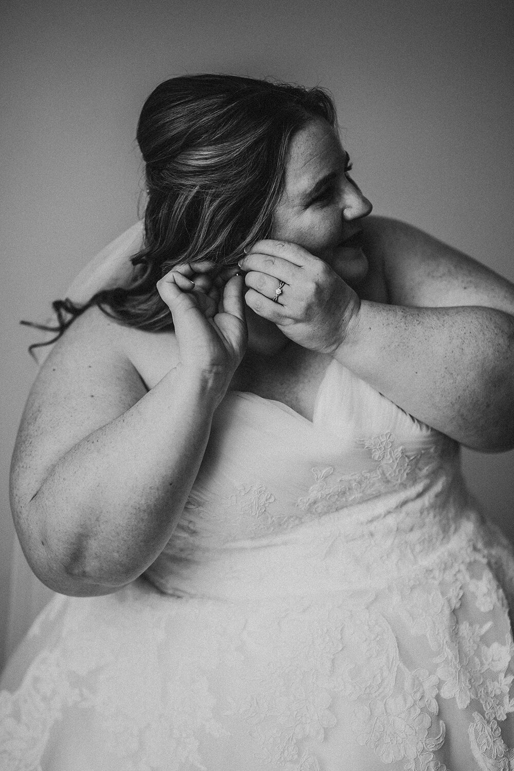 bride putting on earrings 