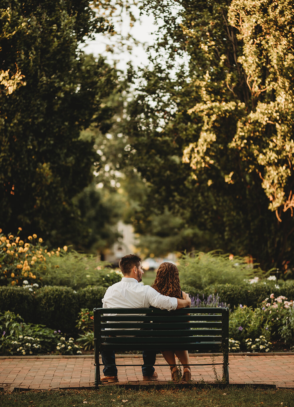 couple sitting on park bench 