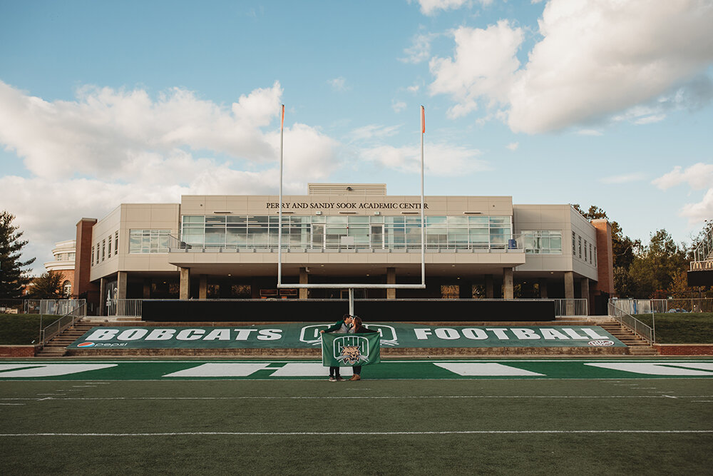 couple portraits on football field 