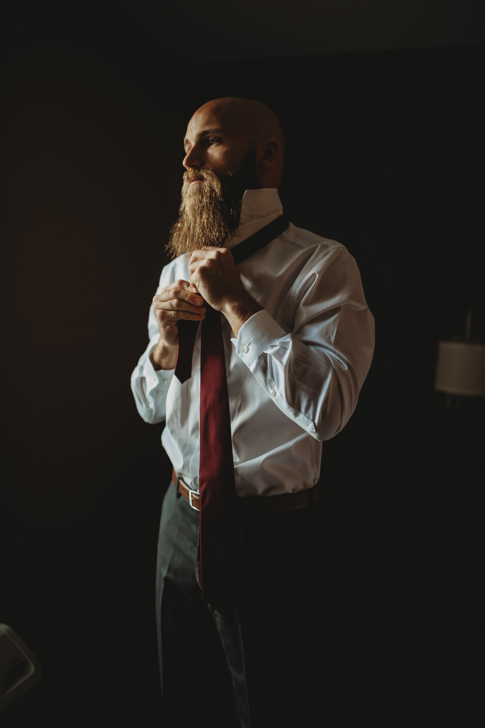 groom putting tie on 