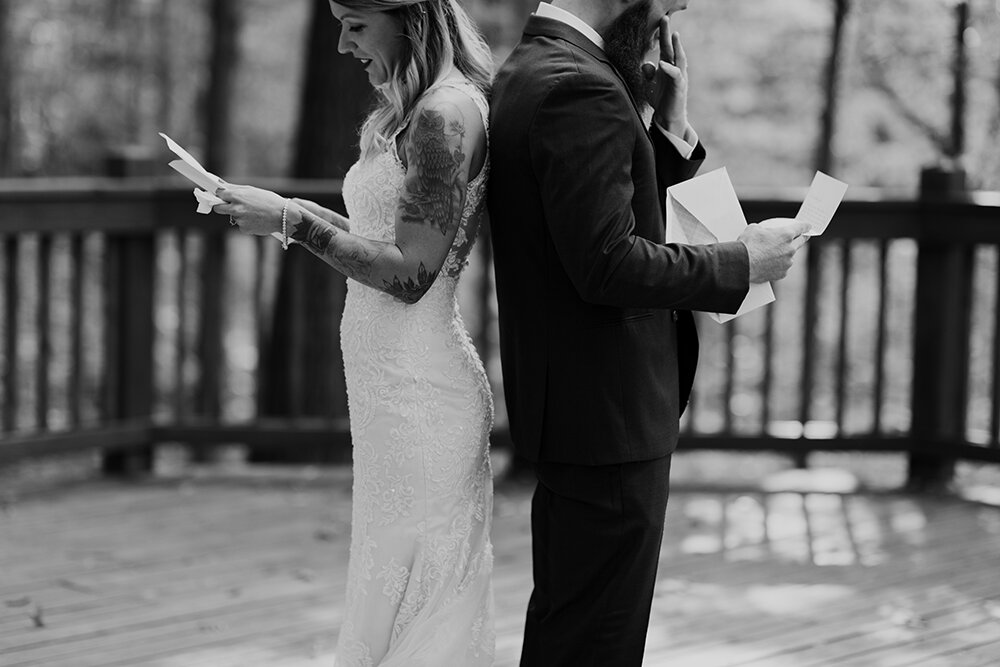 bride and groom reading letters 