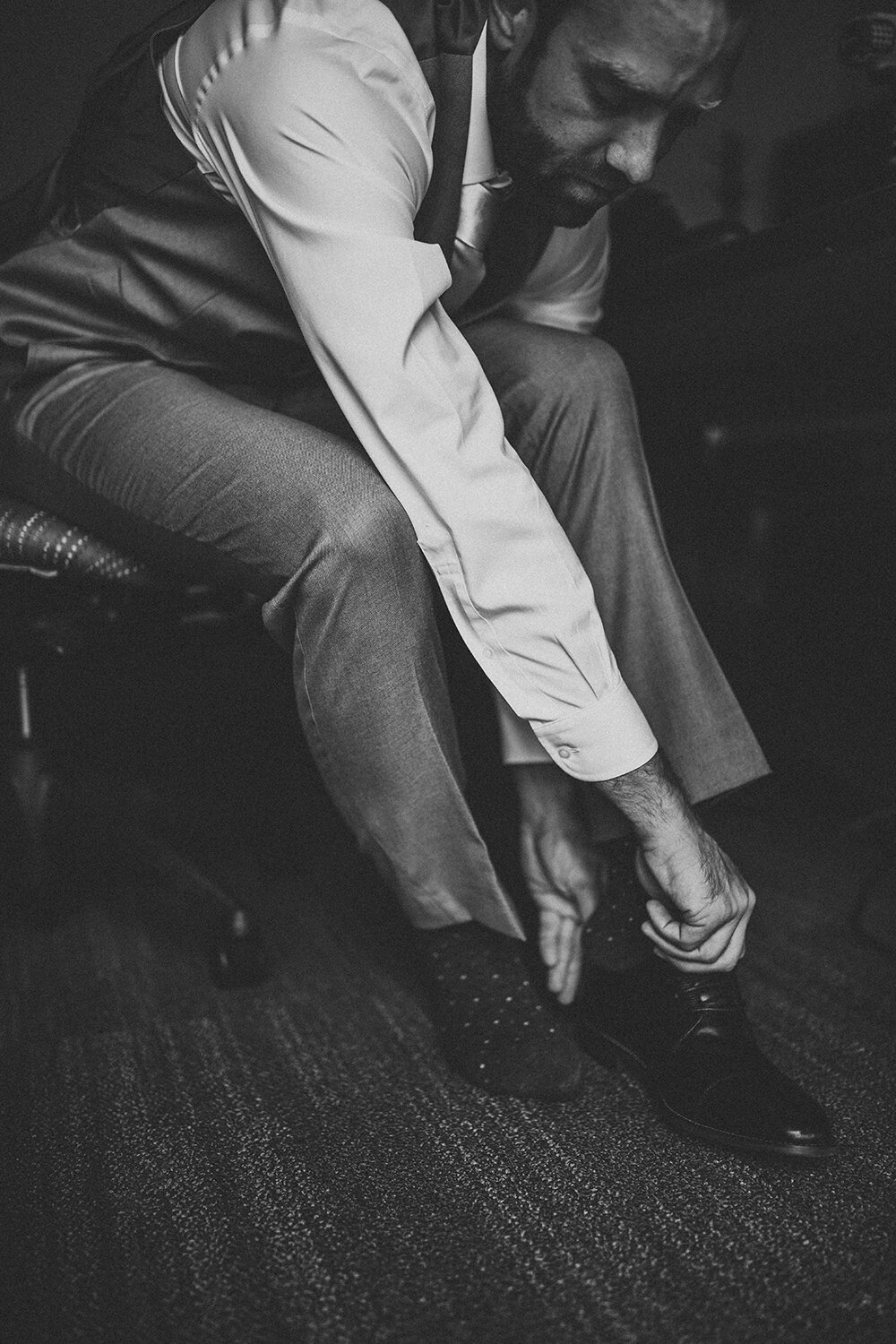 groom putting shoes on 