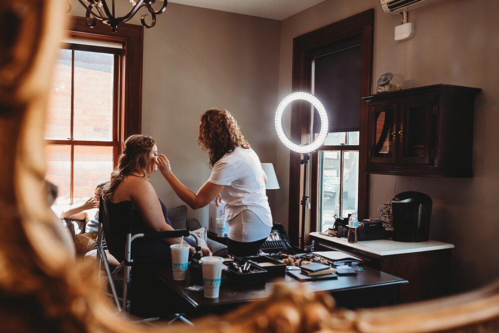 bride getting makeup done 