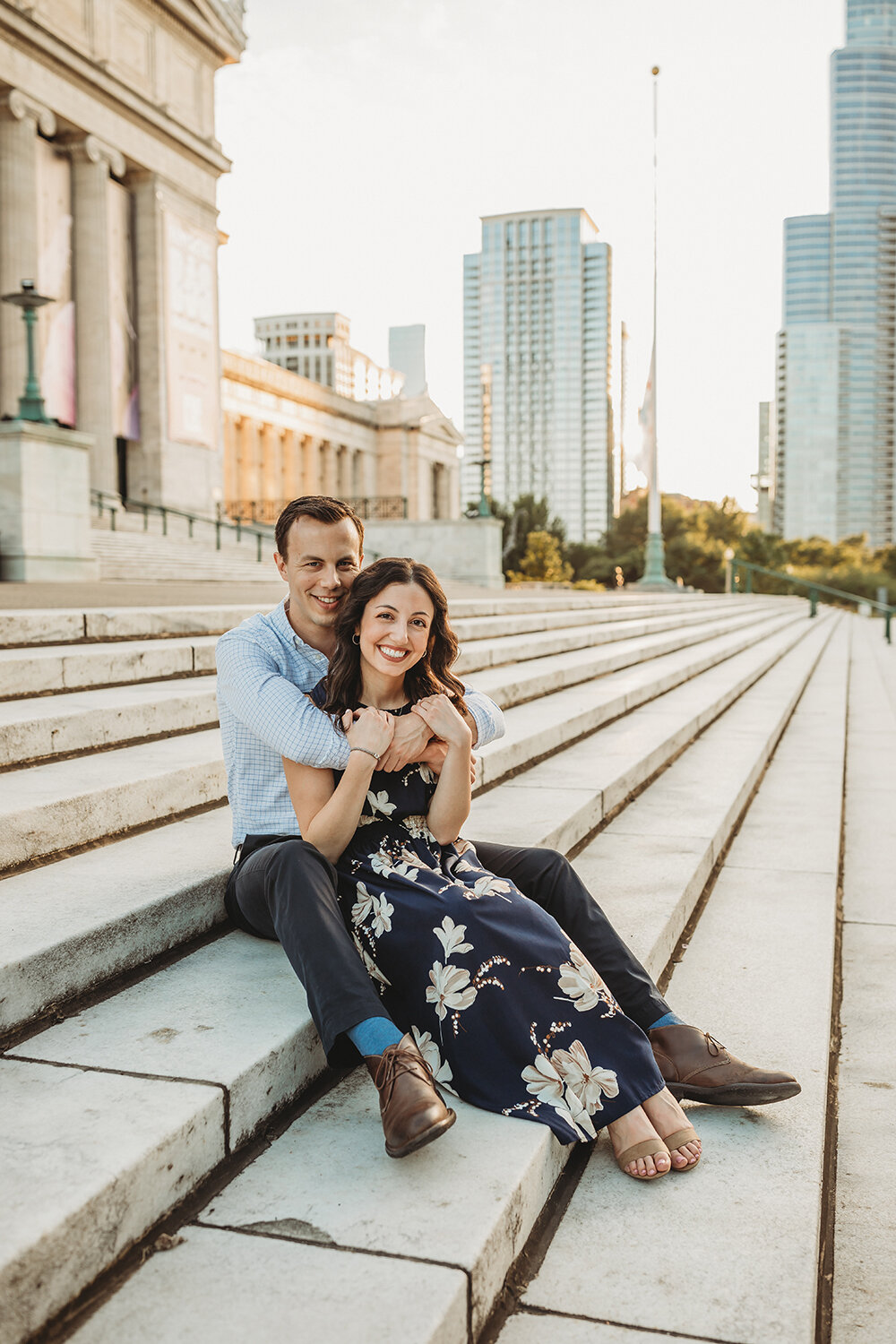 couple sitting on steps of museum 