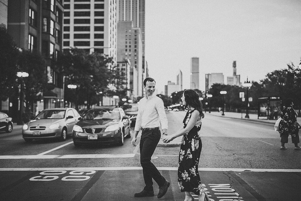 couple walking downtown on crosswalk 