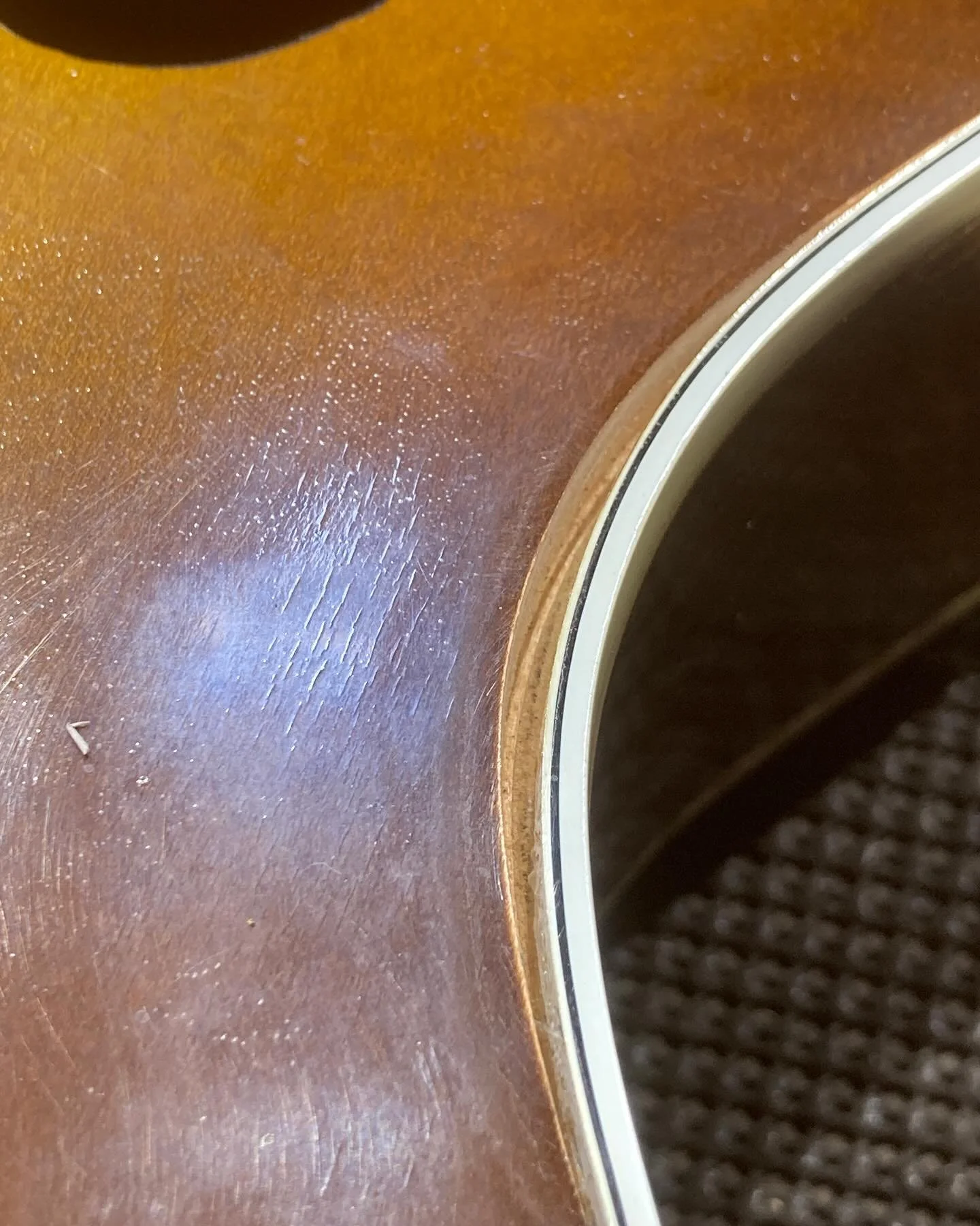Top waist binding shrunk too much to heat and glue back?
Gently release it all the way around to the fretboard extension. 
There is always a little extra hiding underneath.
A bit more heat ( careful here! ) and you should be able to slide it out.
No 