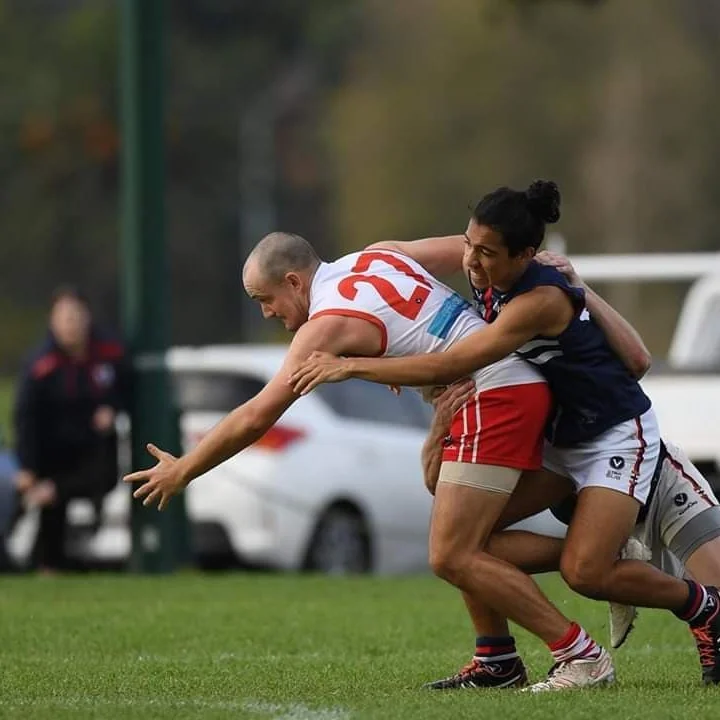 Luke Bags is an integral member of SMDFC both on and off the ground. He jumper number and playign years are nearly the same- he’s been running out as our ruck/ half forward in the #14 for 13 years (pictures in a replacement after an unfortunate instance of the jumper being torn in 2018), 2020 will be a good year for Bags on that basis. This ‘angry bald man’ can be found having some casual Friday beers during the season or on one of may other sporting grounds/courts. Luke is adept at basketball, golf and cricket- all washed down with a healthy beer or 2.