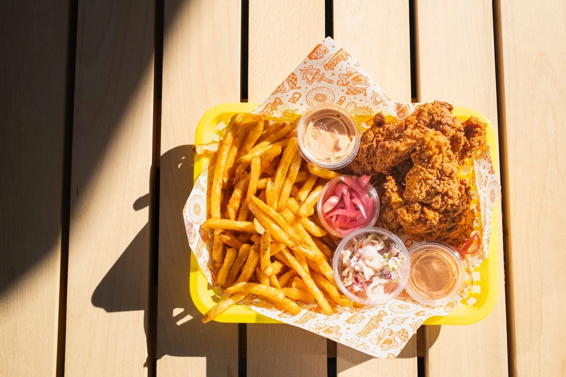 the 🐔 jumbo chicken tendie box of fun 🐔 is a newer addition to the Cafe Racer universe at Oak Street - have you tried it yet? 👀 
we fry up our JUMBO tenders to order and give em to ya, either 3 or 5 depending on how you&rsquo;re feeling, with a he