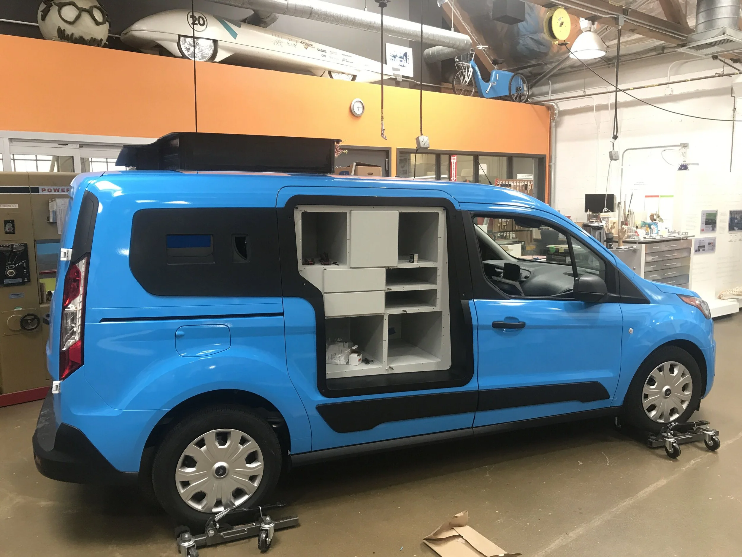 The locker and curbside compartments where powder coated sheet metal assemblies that were put together outside the van, then slid into place through the bezel.