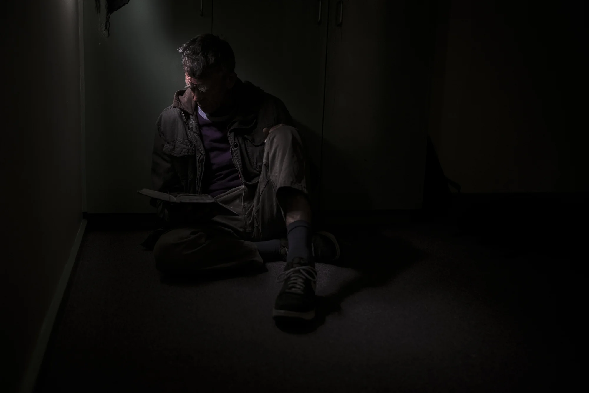  Healsville, Australia. Asha Lang is seen reading pages of the Bible in his government provided accomodation."I do believe there is a god. I find some of the bibles passages I can relate to." Asha explains his thoughts on religion from the bedroom of