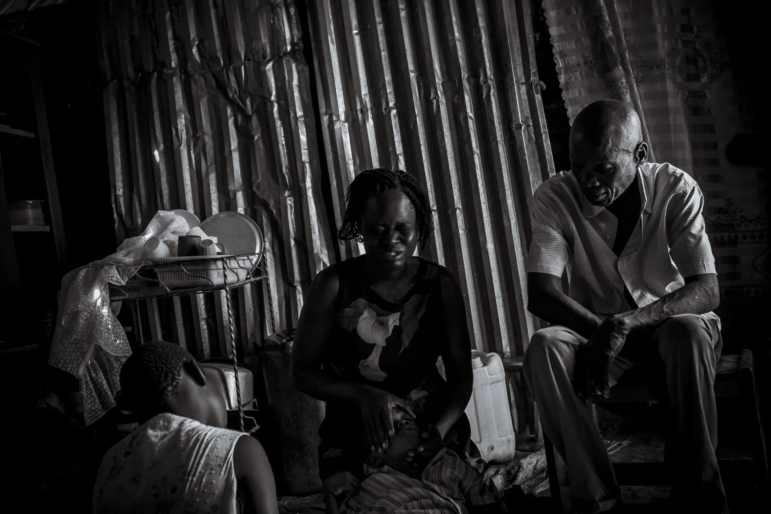  Ojwina, Lira District. The mother of seven year old Ezra Moro, Agnes Nangobi breaks down whilst explaining her families recent experiences raising a child with a disability. Her family has had its home destroyed by an angry mob who believe Ezra and 