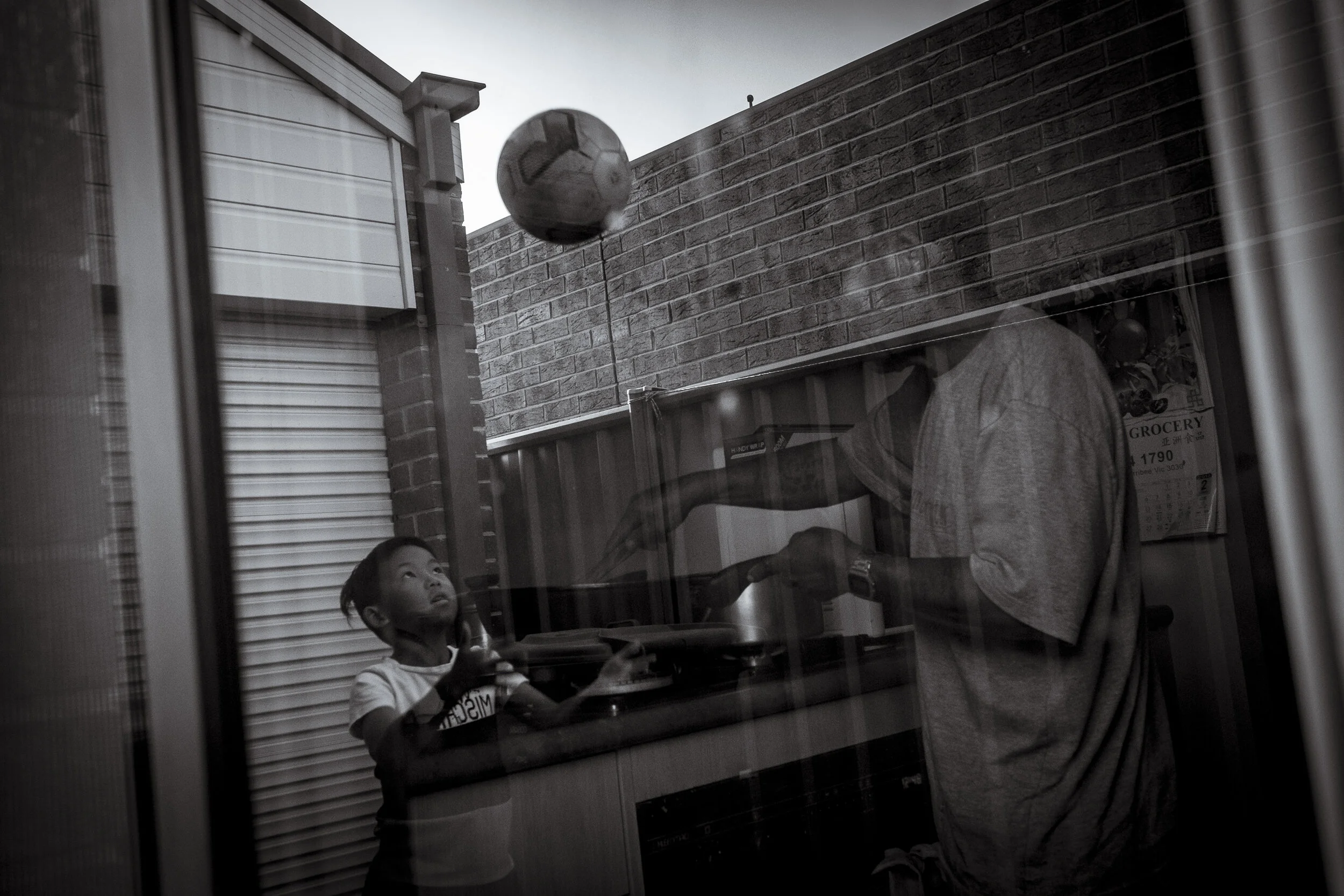  Wyndham Vale, Melbourne. Eight-year-old twin, Andrew Htoo, plays outside after school as his father Roh Htoo cooks a curry for the family meal. The ingredients that combine to provide the sense of place are many, and the methods to assist can be as 