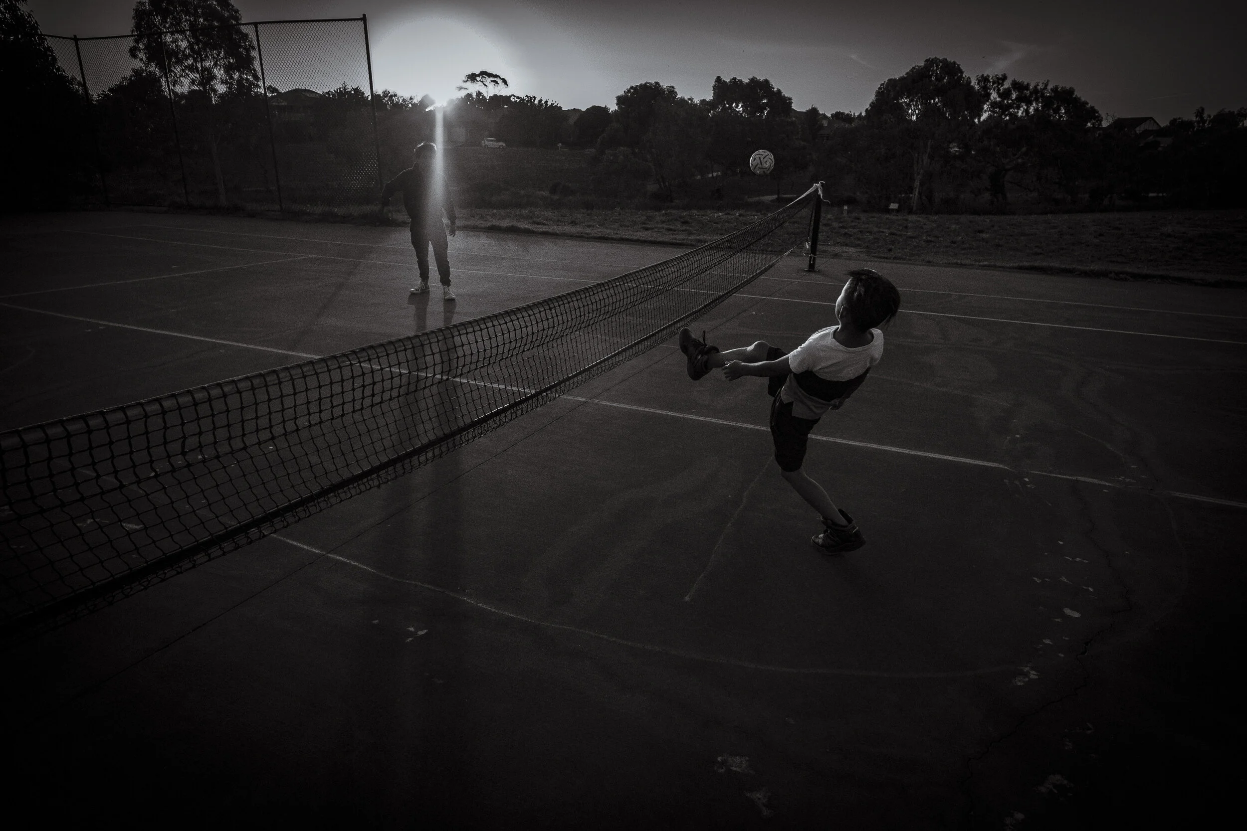  Wyndham Vale, Melbourne. Cousins, Loo Wah Htoo (Poo Aung’s son) and Mou Lay play the traditional Burmese game of Chinlone in the late evening light. Having that connection to traditional culture is shared by most of the ethnic minorities of Burma yo