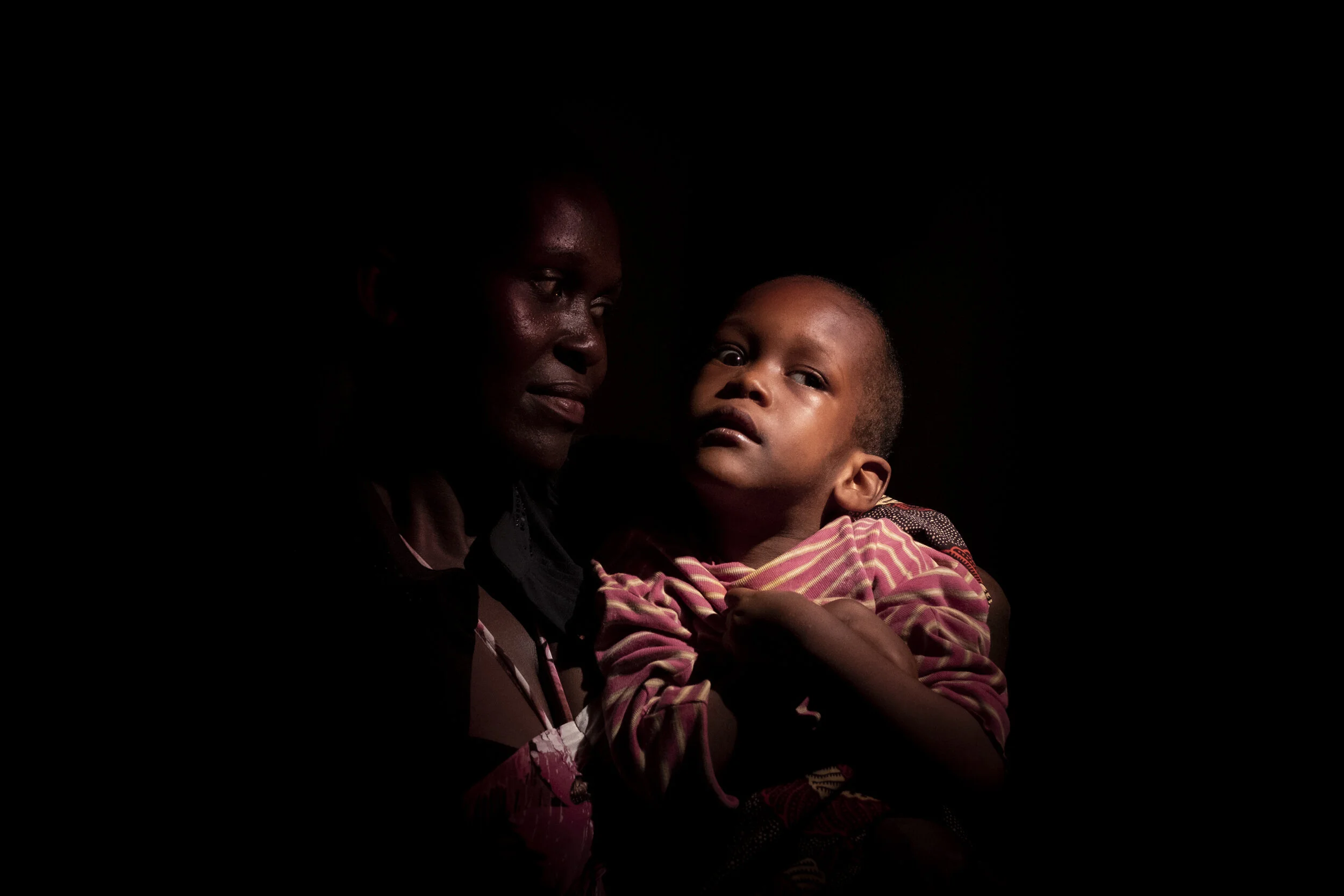  Entebbe, Uganda. Catherine Munaaba's daughter Grace Mugisha was born with Cerebral Palsy. The child’s father left her and she has had to re-locate to a different region of Entebbe due to ill-will directed at her and Grace. She never considered killi