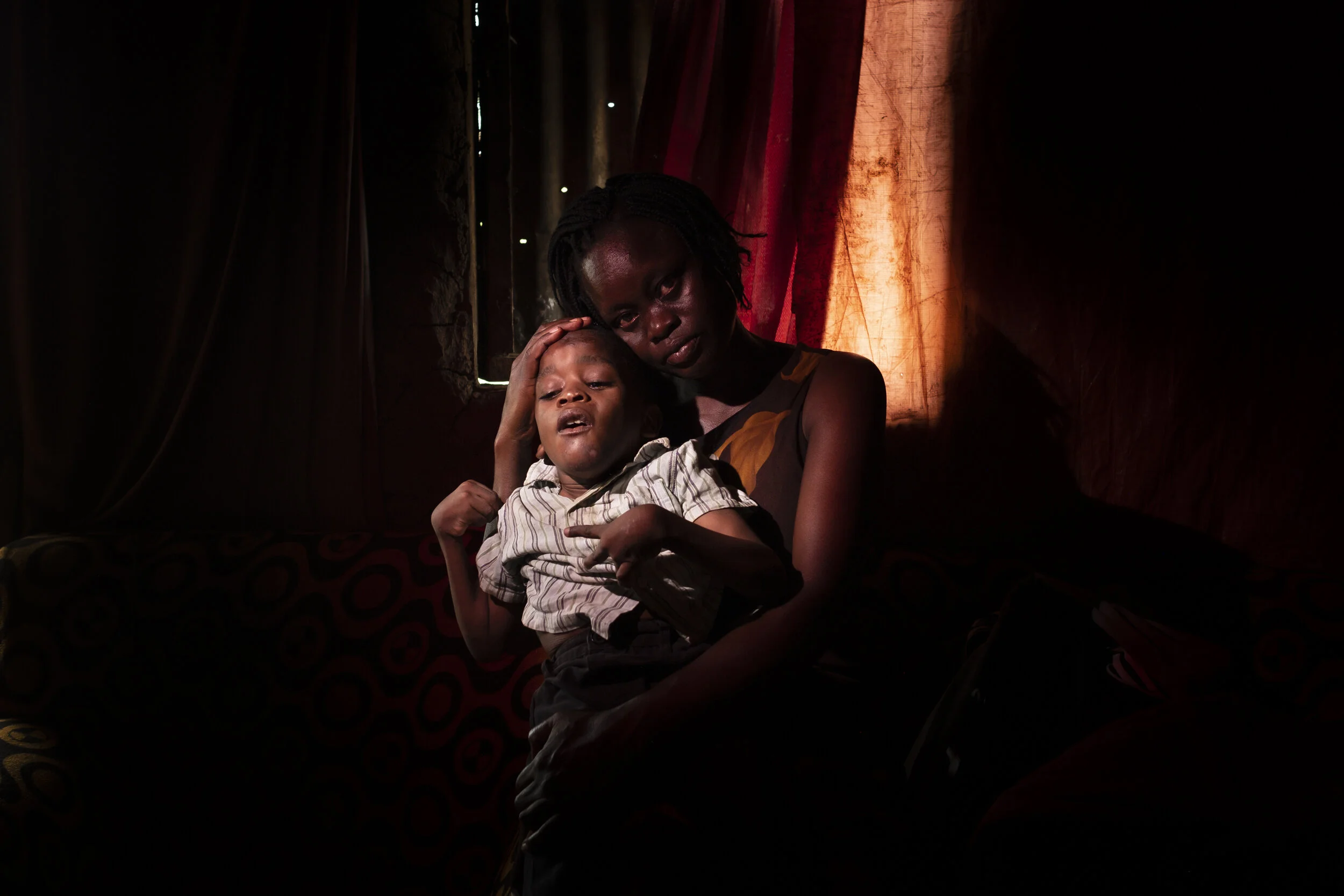  Ojwina, Lira District. Seven-year old Ezra Moro was born healthy. At age four he began to show signs of  turned in feet and loss of speech. Within three years he was completely disabled.  Ezra hasn’t been formally  diagnosed but his mother, Agnes Na