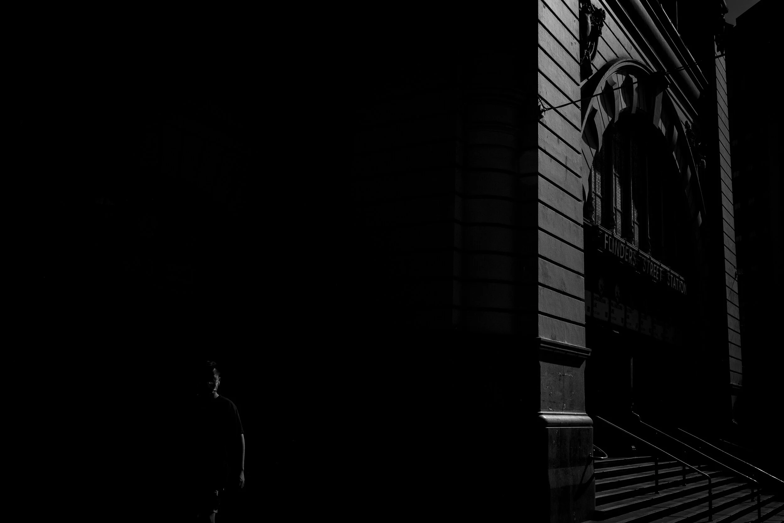  26/03/20 15:36 pm, Flinders Street Station.  At a time when the iconic clock opening would be flooded with commuters rushing to get their train home, the cities lockdown laws have turned the station into a lonely relic of its past.  