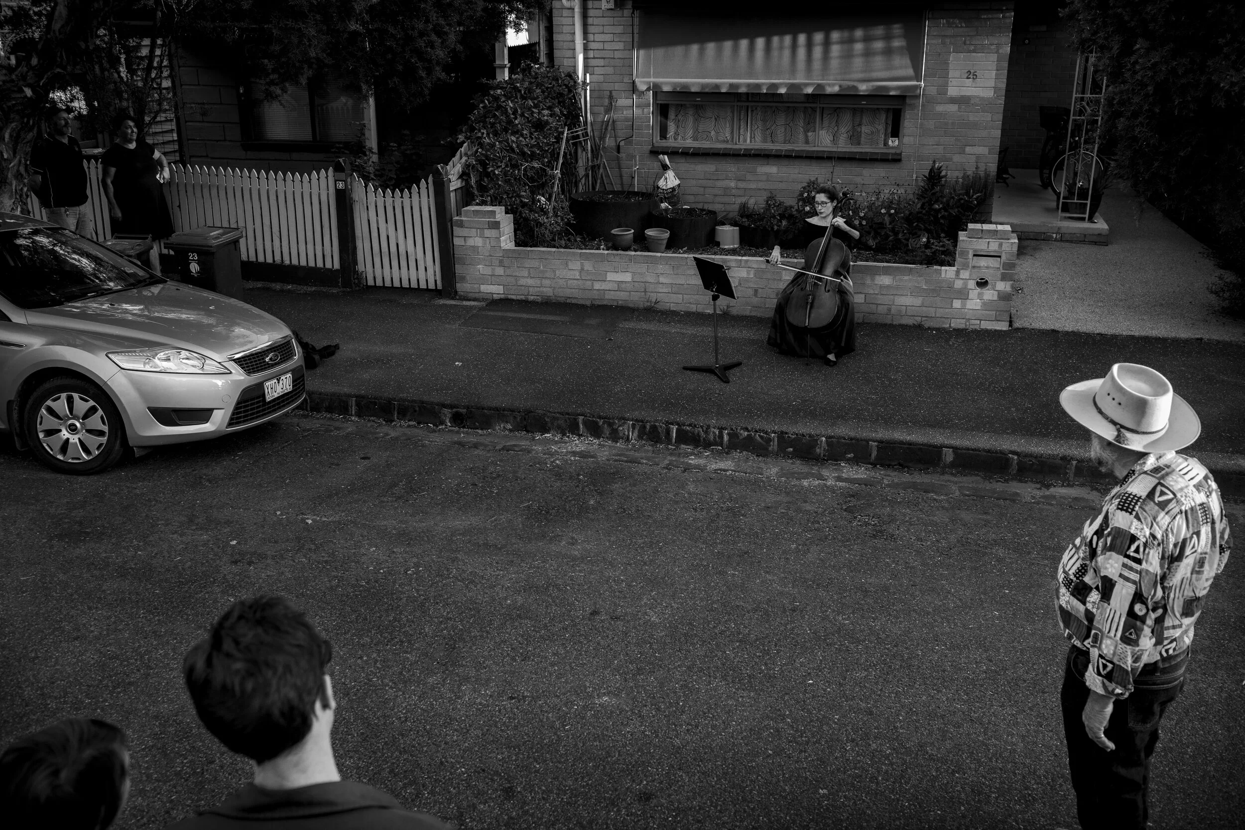  31/03/20 17:41 pm, Brunswick. Former Melbourne Symphony Orchestra Cellist, Josephine Vains plays a social distancing 'concert' for her neighbourhood. Random acts of kindness and togetherness have arisen within the community. As the unemployment rate