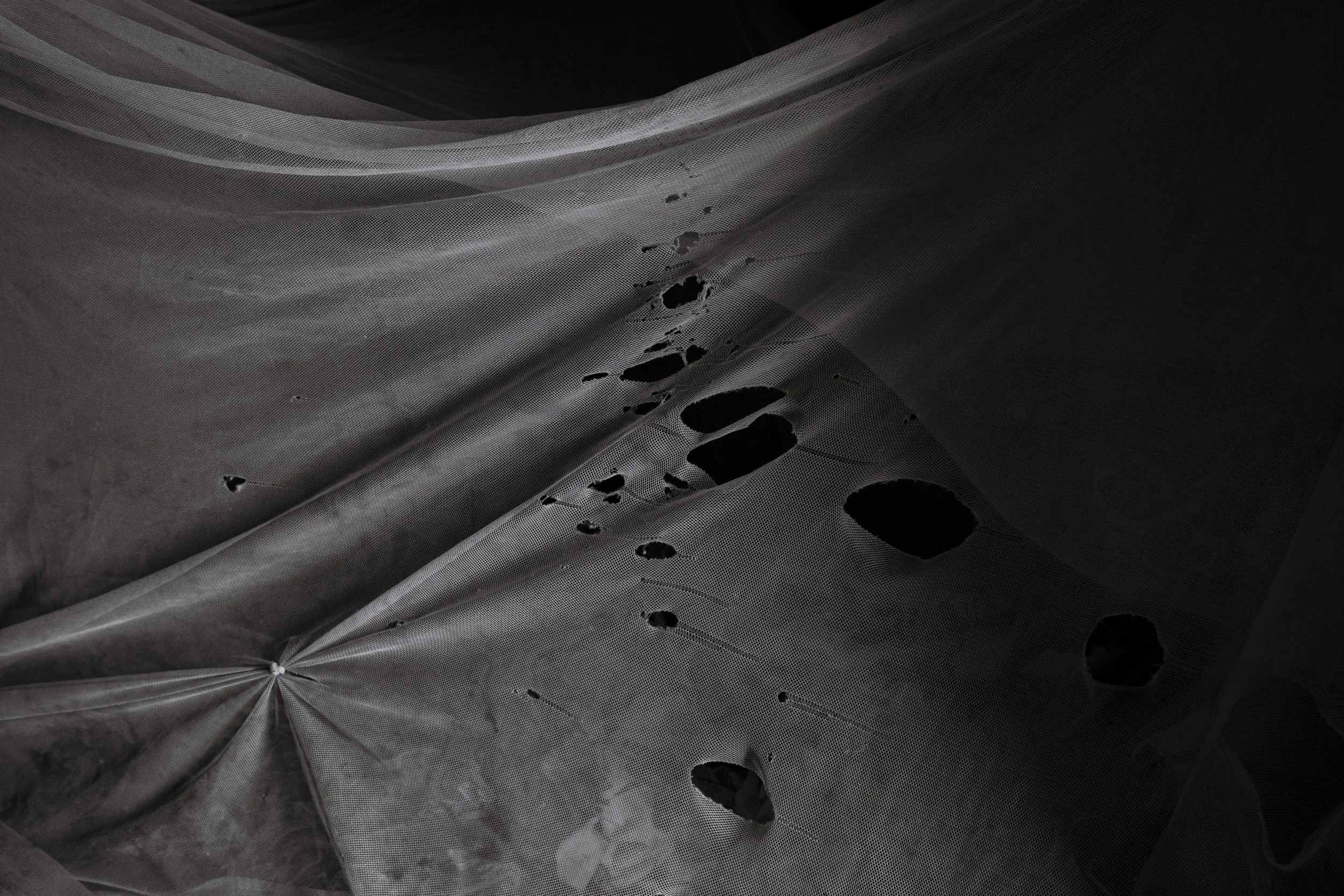  27 February 2020. Obur, Soroti District, Uganda. Ineffective Mosquito nets, such as this one in the room lived in by thirteen-year-old Silus Odaii who lives with Down Syndrome, enable the spread of malaria which further fuels the health issues faced