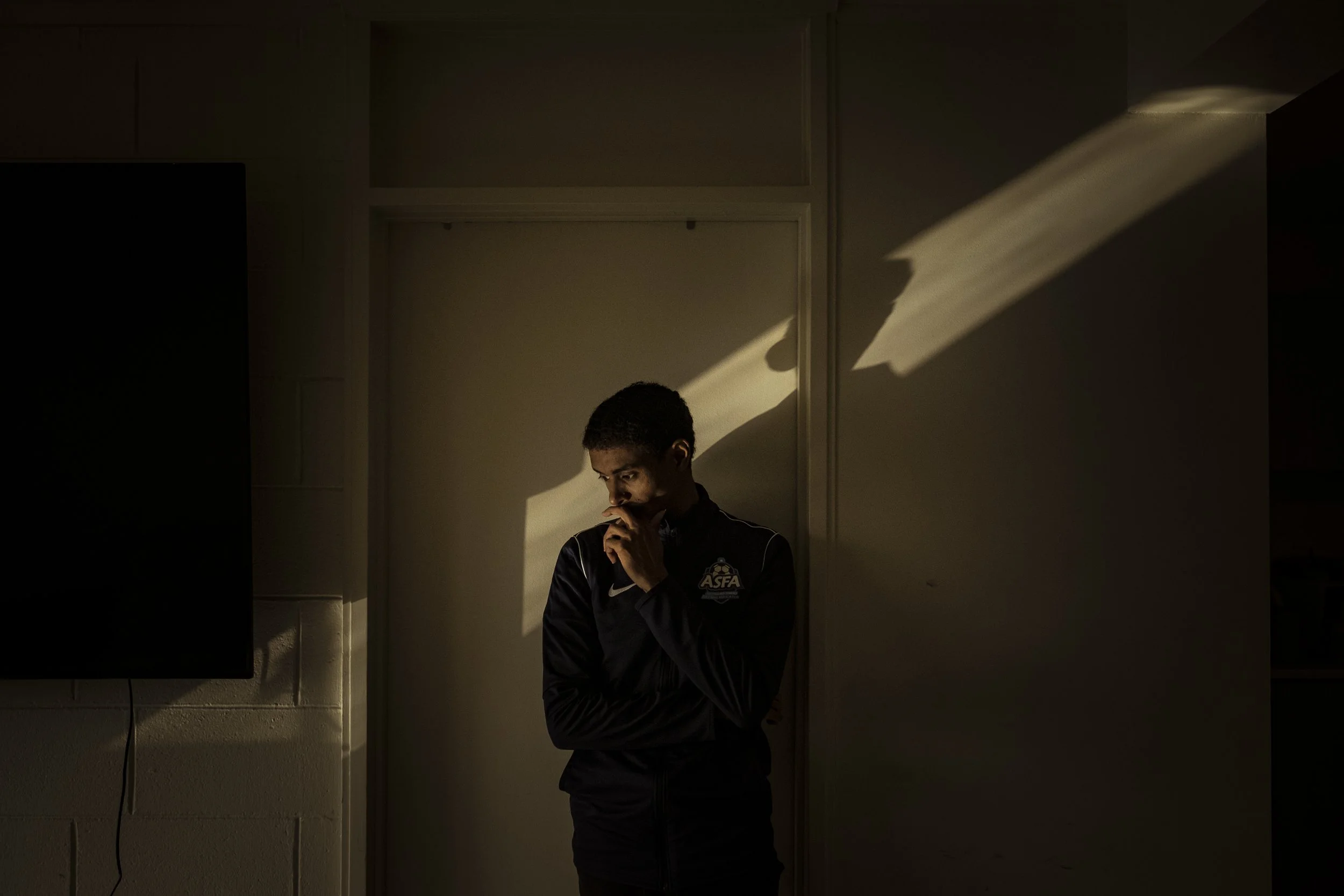  4 June 2021, 76 Canning Street, North Melbourne, Australia. Ahmed Dini is bathed in sunlight whilst taking a contemplative moment in his apartment at 76 Canning Street. Ahmed, known widely as simply 'Dini' was and still is a resident of the Canning 