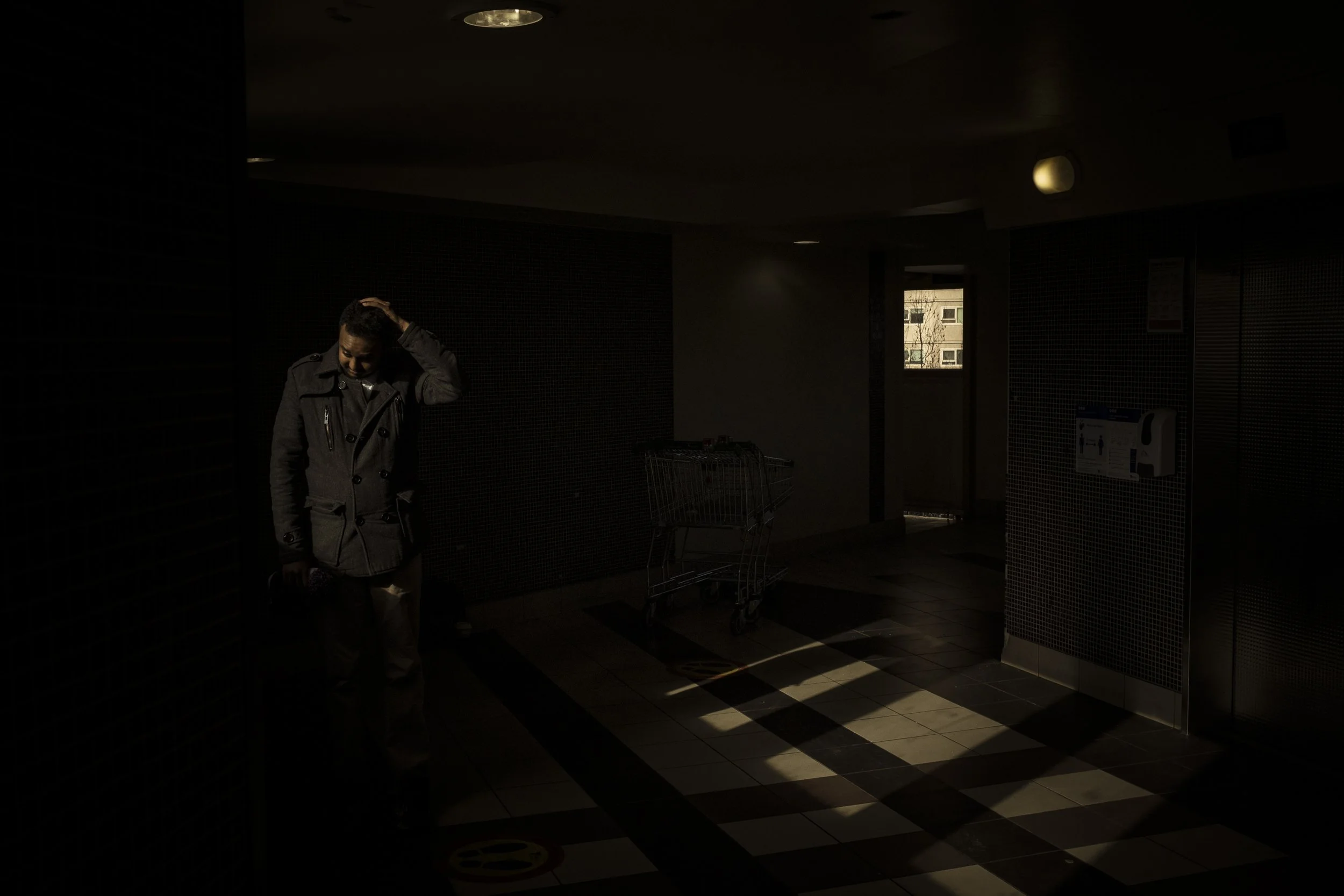  13 June 2021. 33 Alfred Street, North Melbourne, Australia. Barry Berih, born in Australia to Eritrean parents, walks through the foyer towards the lift well as he leaves his apartment building.   In 2020 Berih was one of the 11% of residents who co