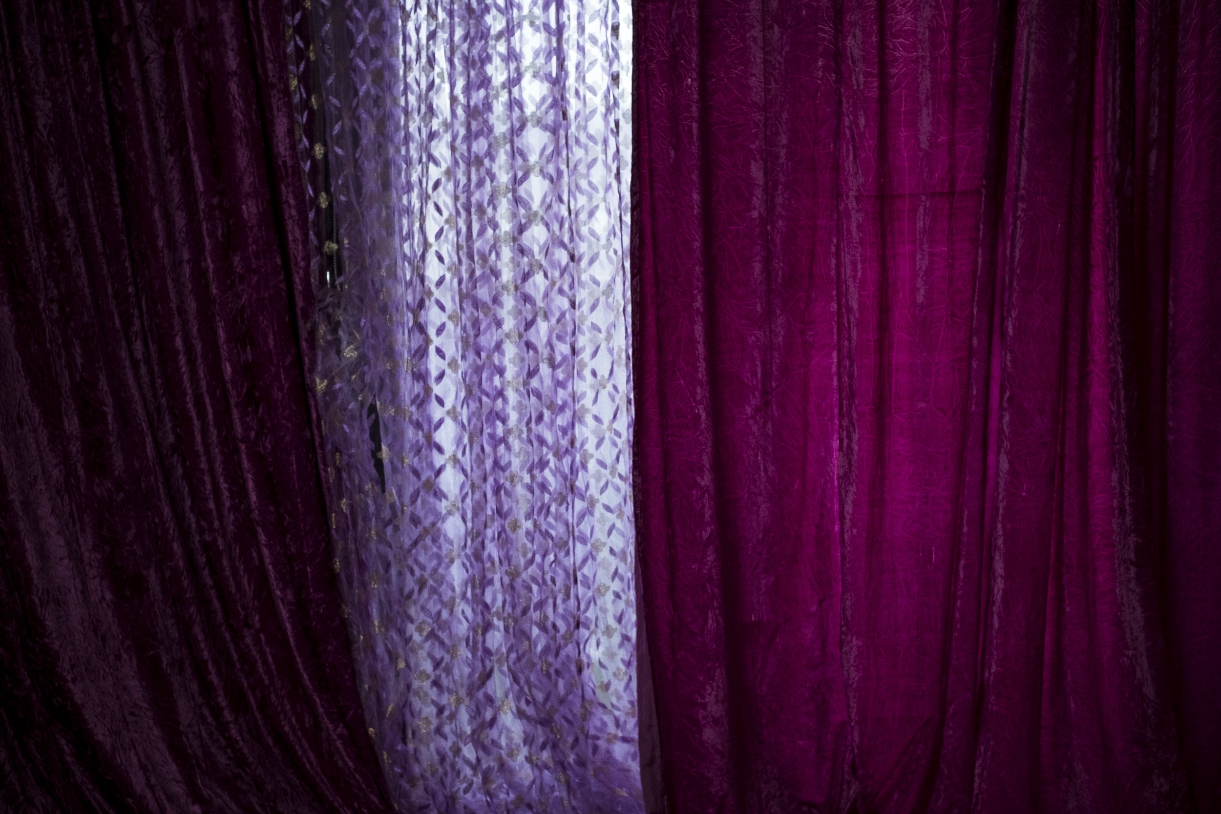  7 July 2020. Nicholson Street, Carlton, Melbourne. Bright colourful drapery at an unused flat in the Carltons 'Red Building' housing estate. The Red Building is separated from the Carlton housing estate proper by two blocks and is infamous for its p