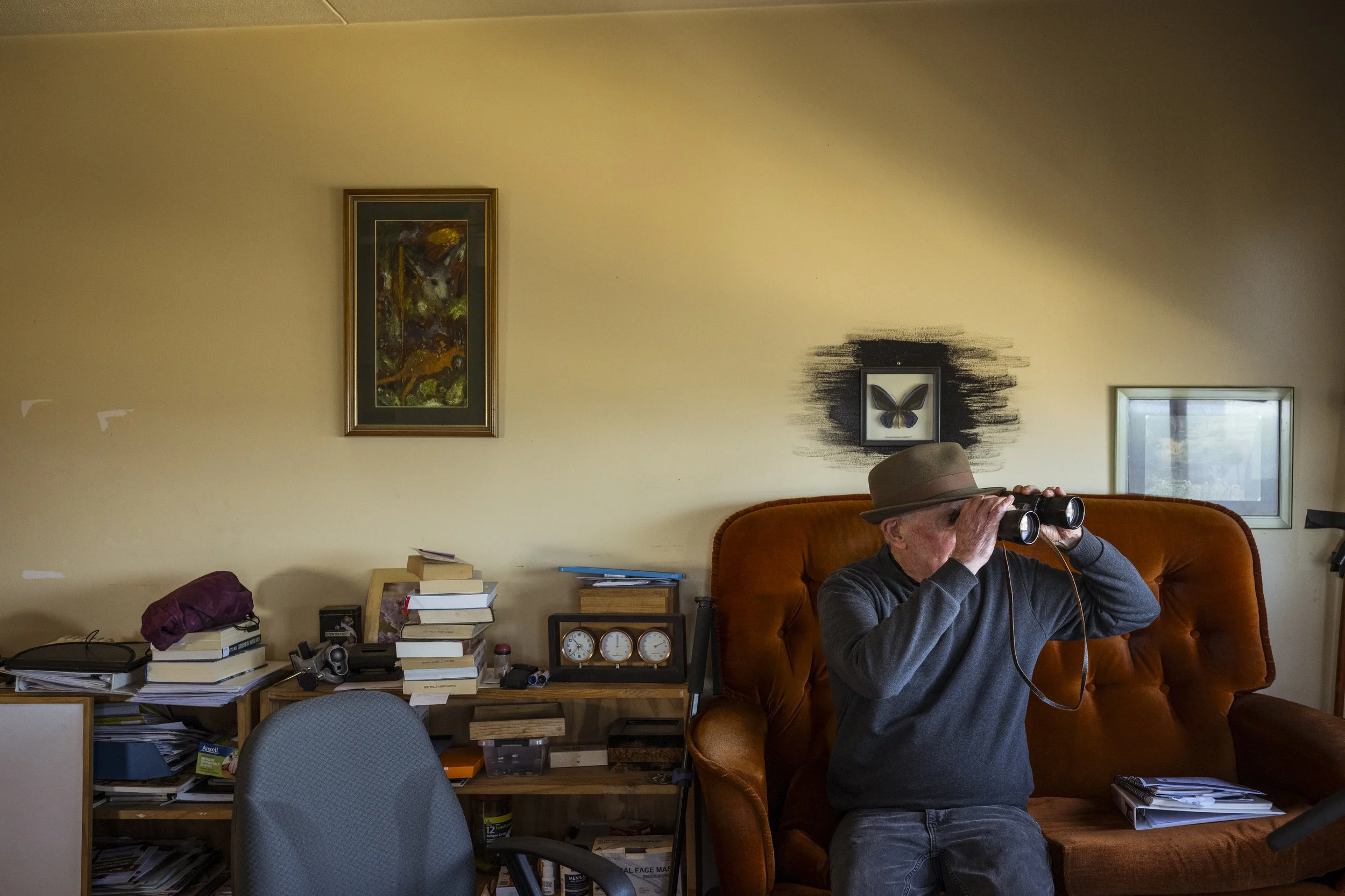  22 September 2025. 150 Victoria Avenue, Albert Park, Australia. 74-year-old Bill McKenzie watches birds flying across the nearby Port Phillip Bay from his living room sofa in his public housing apartment in Albert Park. Bill's tower is one of the de