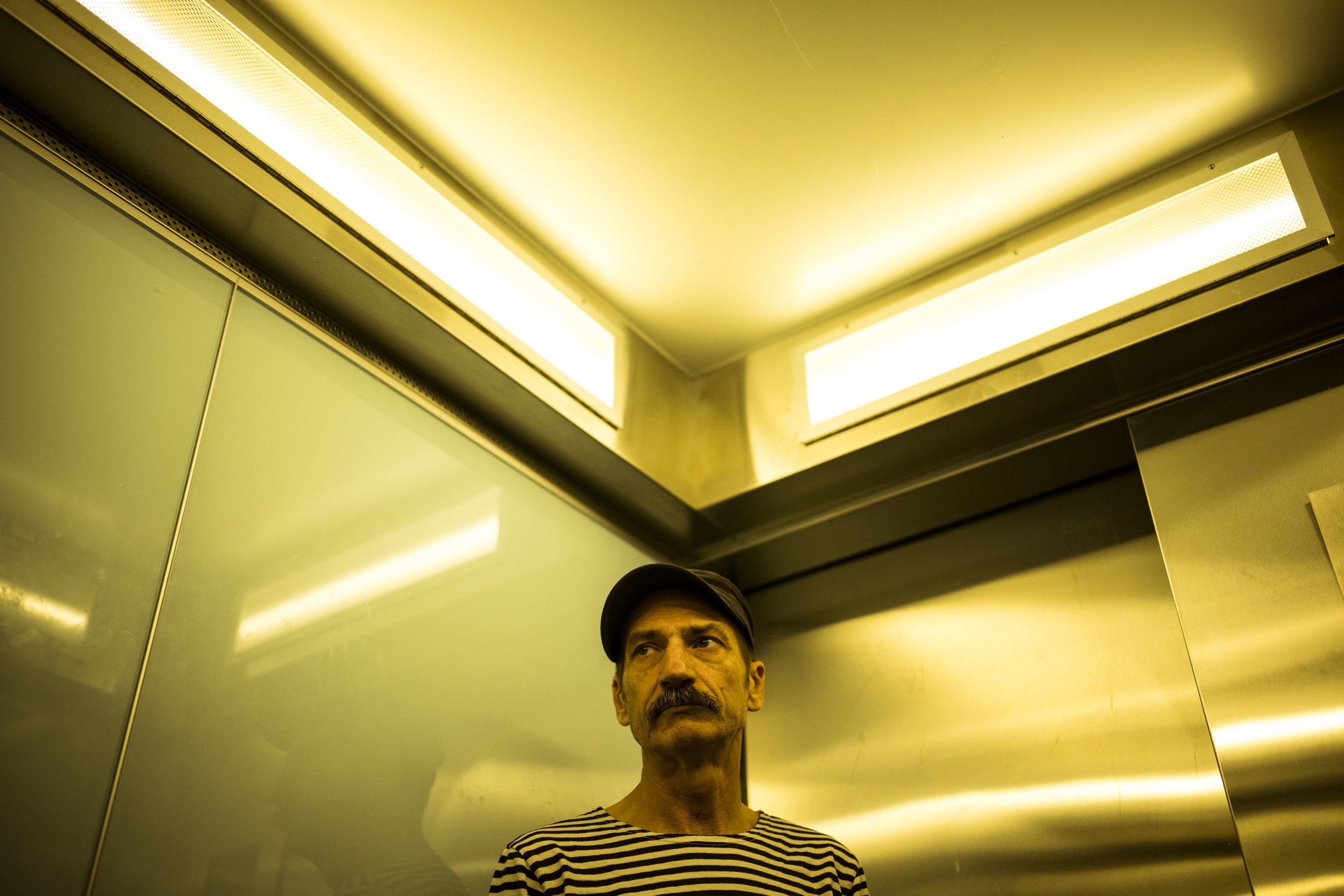  8 October 2025. 1 Holmes Street, Northcote, Australia. Ian 'Hank' Ferguson rides the lift to his tenth-floor apartment in the Northcote towers. Hank, 60, found sanctuary in 2022 in the Northcote tower. It was his escape from homelessness after a bre