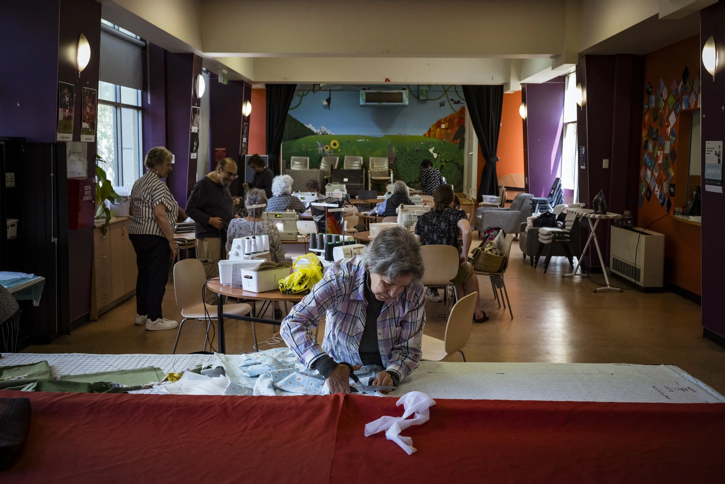  30 October 2025.  150 Melrose Street, North Melbourne, Australia.  North Melbourne public housing resident, Amparo Collazos cuts out a pattern for a pair of pants she is making during her weekly sewing class.   The sewing class is one of the many ac
