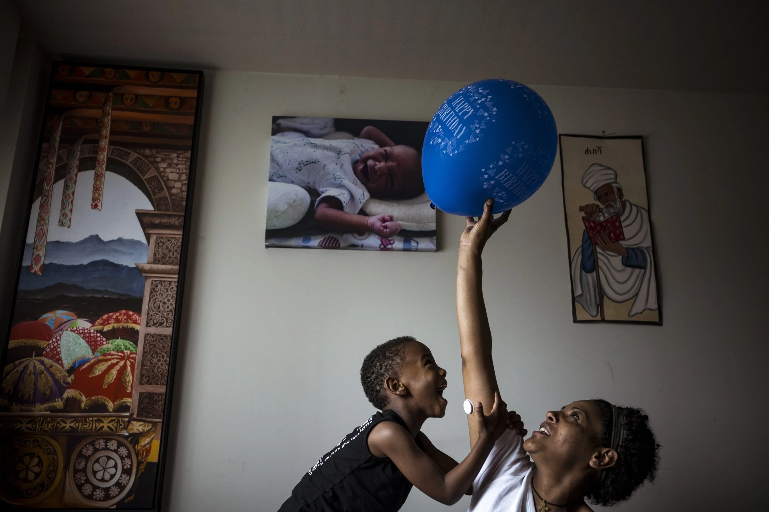  18 November 2024. 126 Racecourse Road, Flemington, Australia. Single mother Bezawit Gizaw plays in the morning light with her son Yeabsira.  'Beza' emigrated to Australia in 1996 from Ethiopia and immediately lived in public housing with her father.