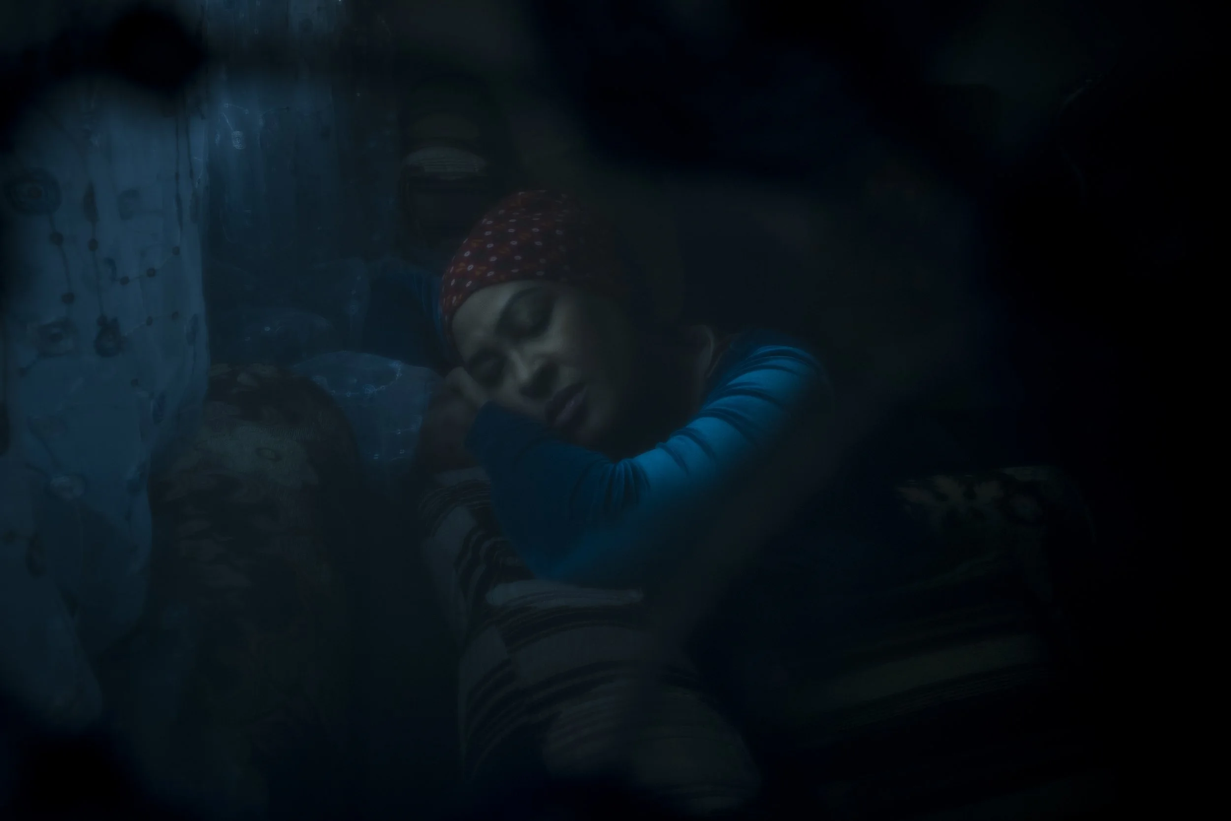  13 June 2021. 130 Racecourse Road, Flemington, Australia. Ruth Eyakem rests on her sofa in the late afternoon light after a long day’s work waitressing.  Originally from Eritrea and a resident on the Flemington estate, Ruth describes the lockdown as