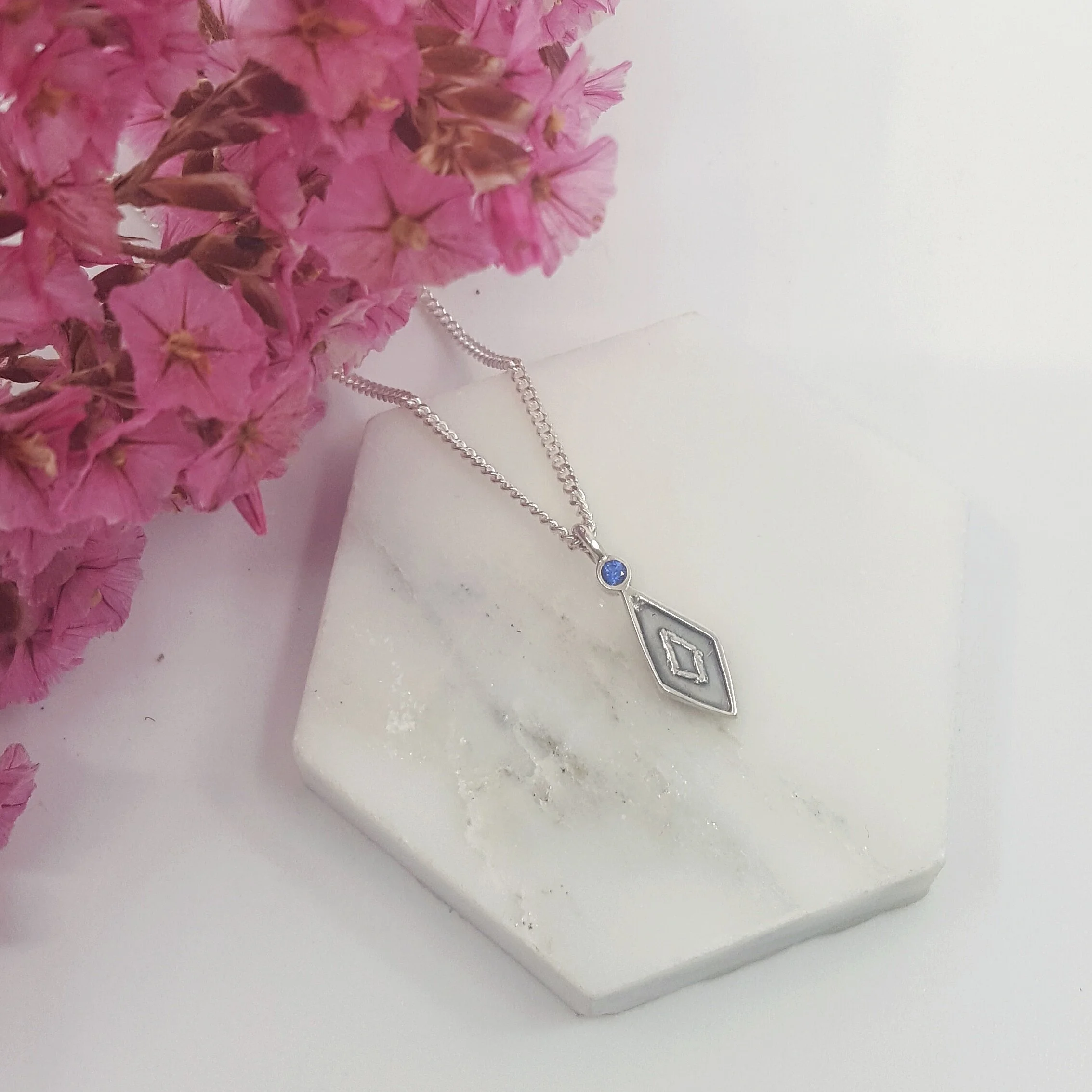 Arctic - Charm pendant with hand stamped diamond motif and blue sapphire (chain included)Charm length - 17mm, Chain length - 55cm$200