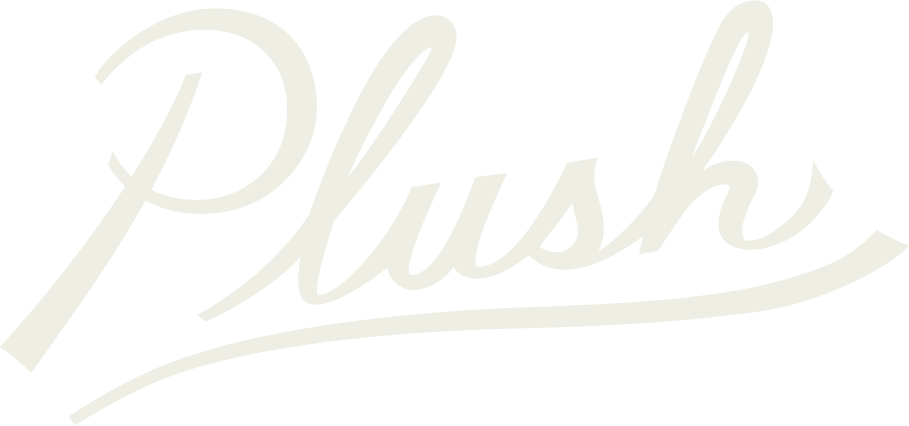 The word 'Plush' written in a cursive, stylized font with a swooping underline.