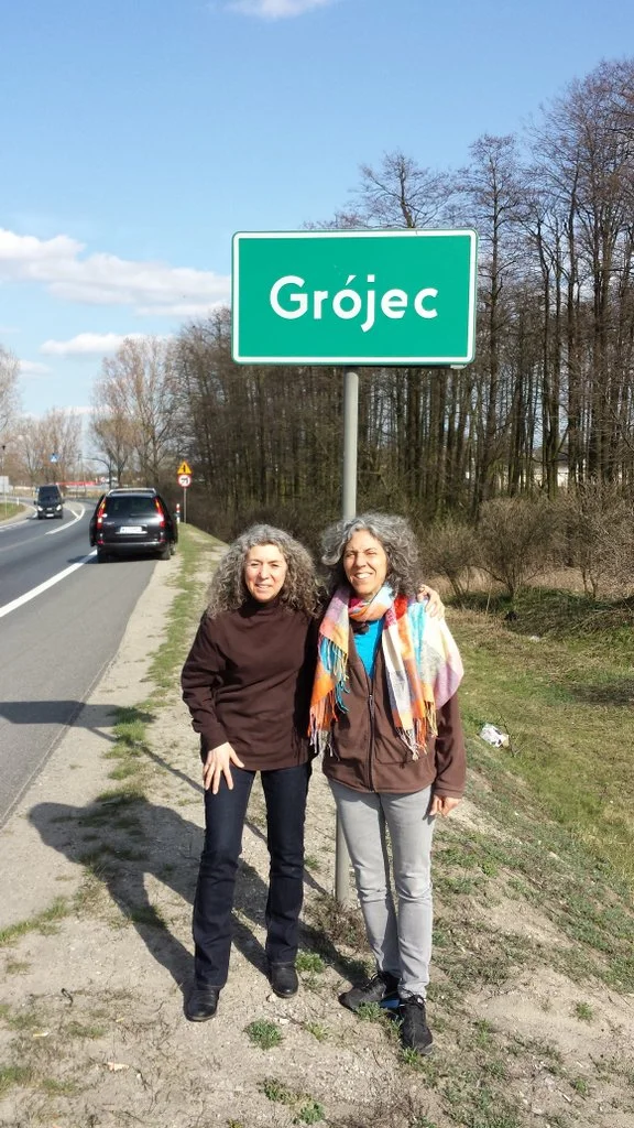 With my cousin, Linda Motzkin (right), in 2014 at the entrance to our parents' hometown of Grojec, Poland.