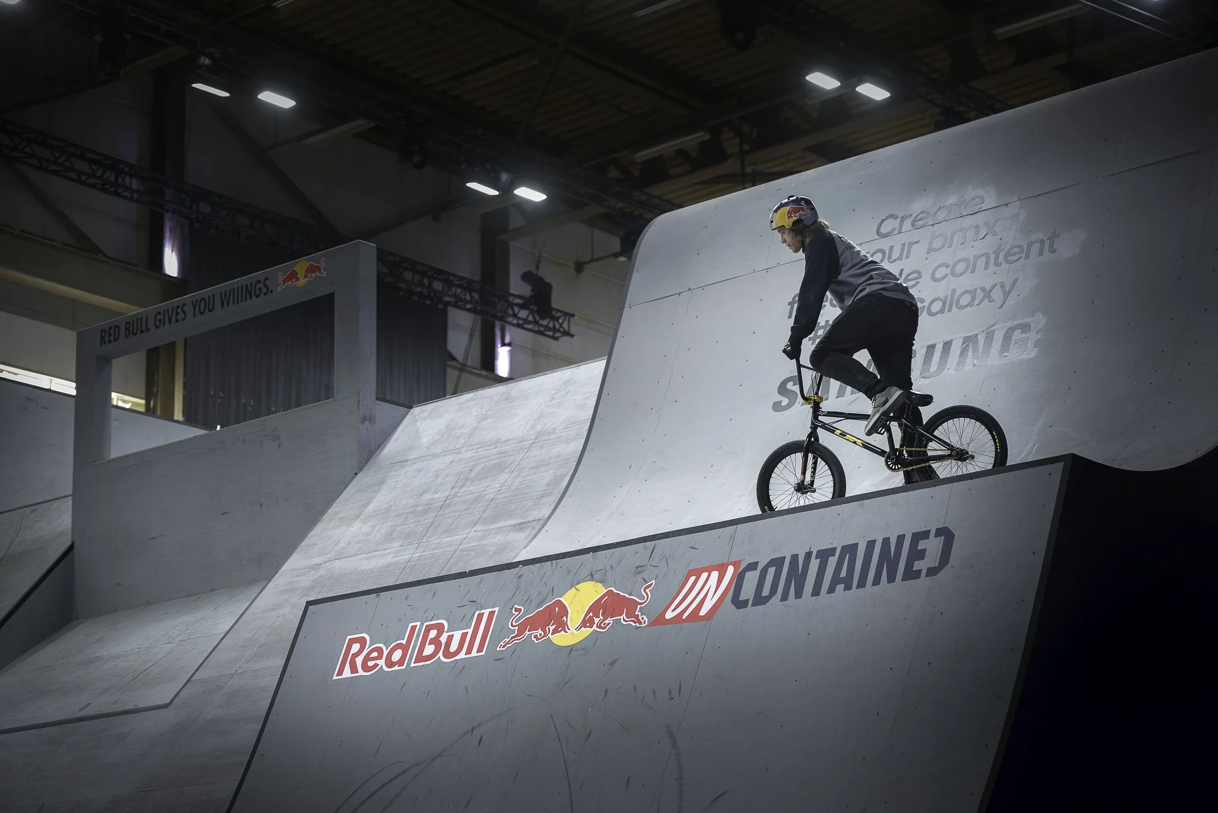 Red Bull BMX indoor event photography - rider performing trick during live brand activation.