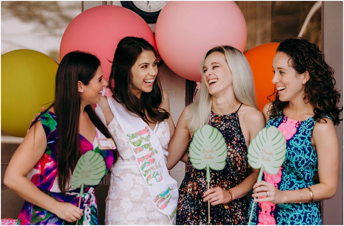 Lilly Pulitzer Bridal Shower Bride laughing with bridemaids and props