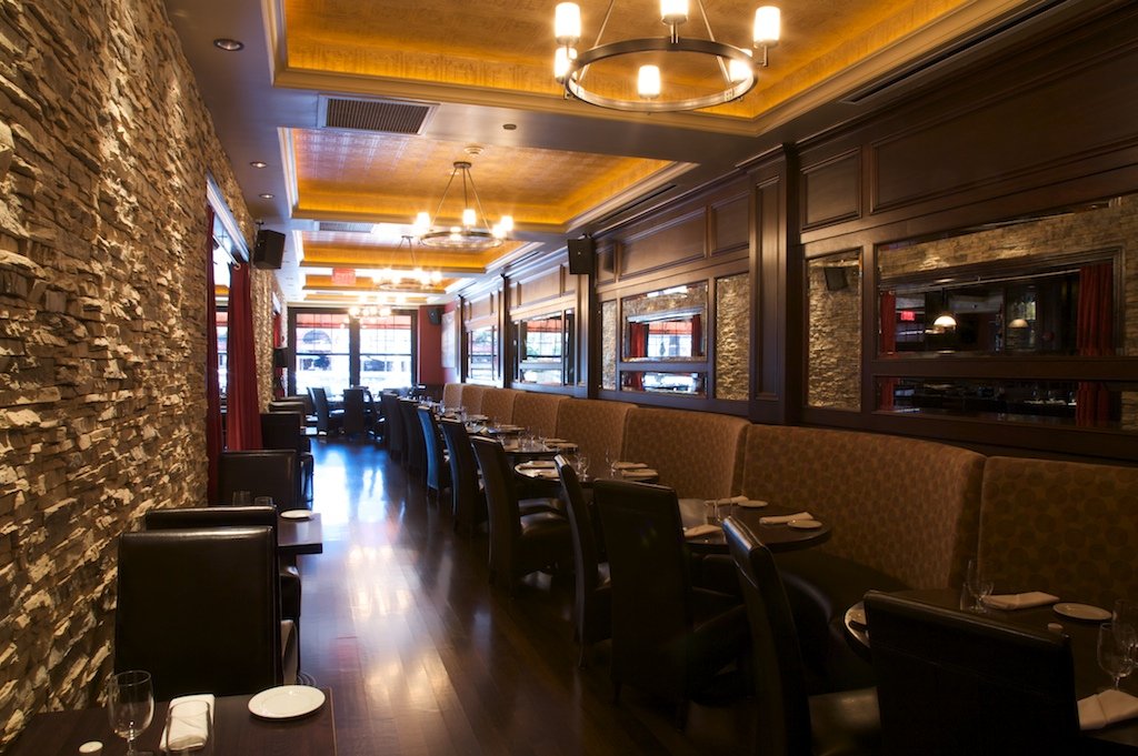 Hudson Grille dining room with stone walls and leather banquettes