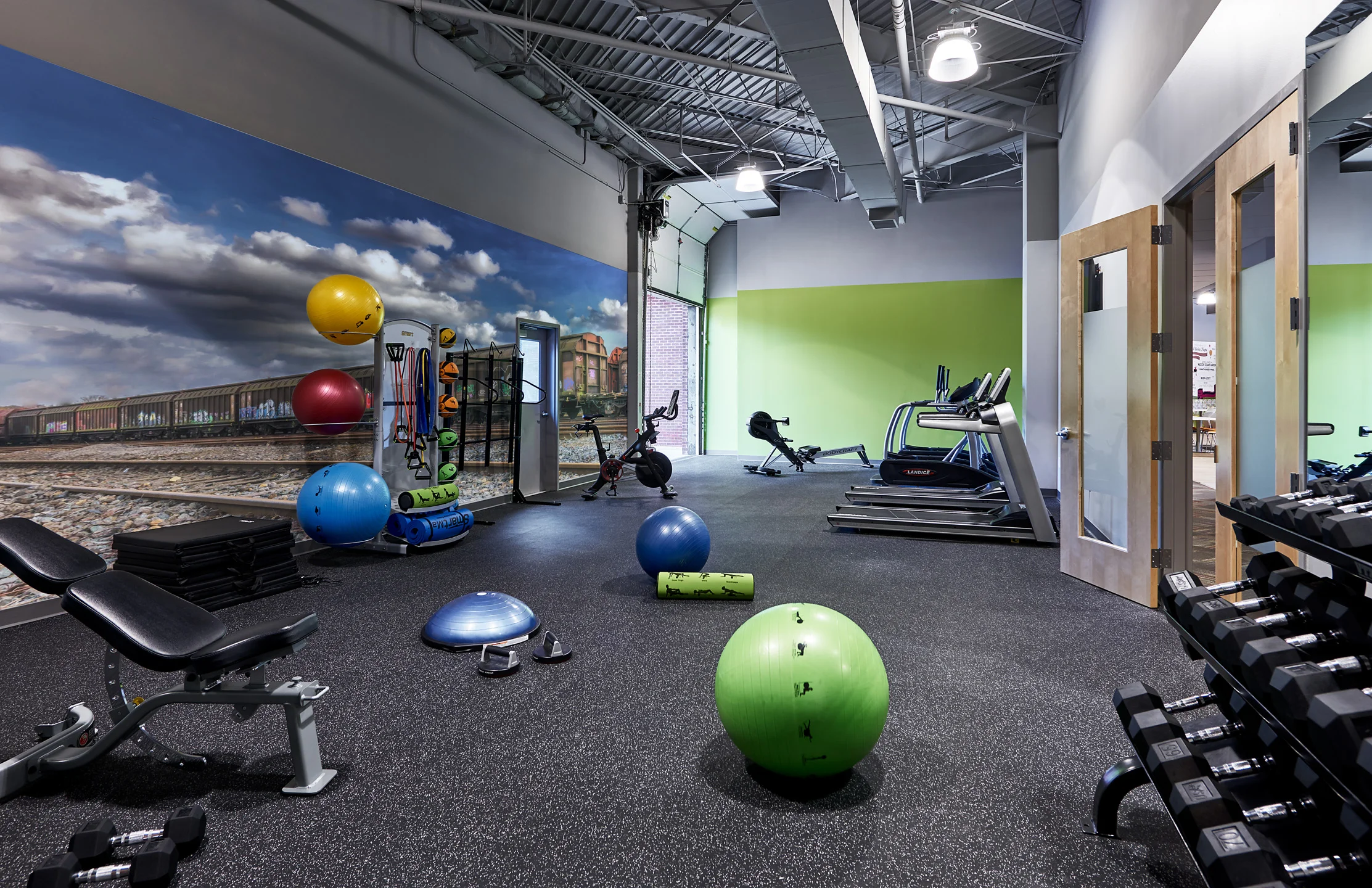 Fitness room connected directly to exterior space providing fresh air and day lighting while letting physical activity to spill outside