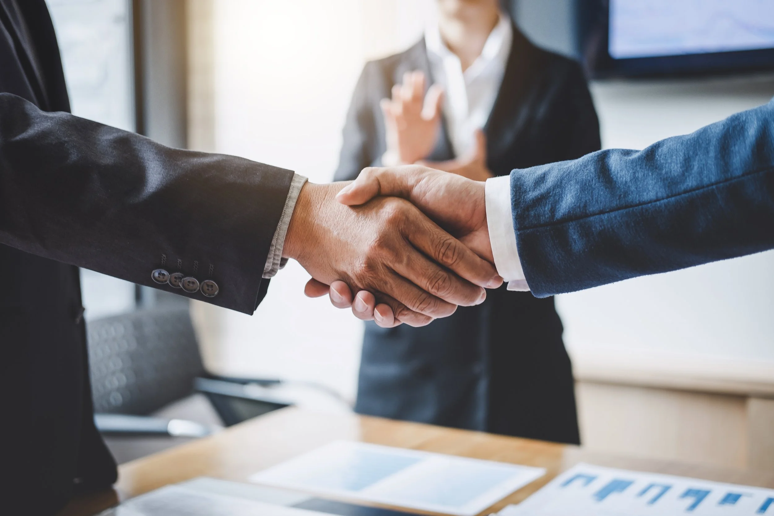 finishing-up-a-meeting-business-shaking-hands-after-discussing-good-deal-of-trading-to-sign-agreement.jpg