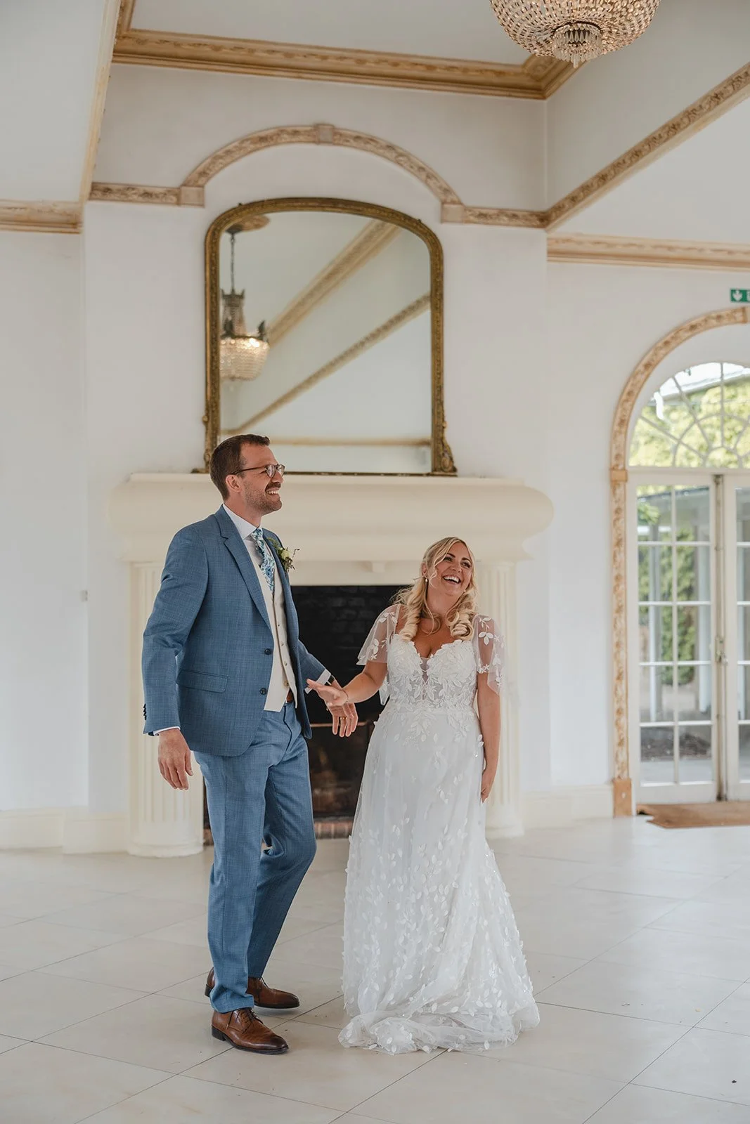 Jonny and Abi smiling inside their wedding venue