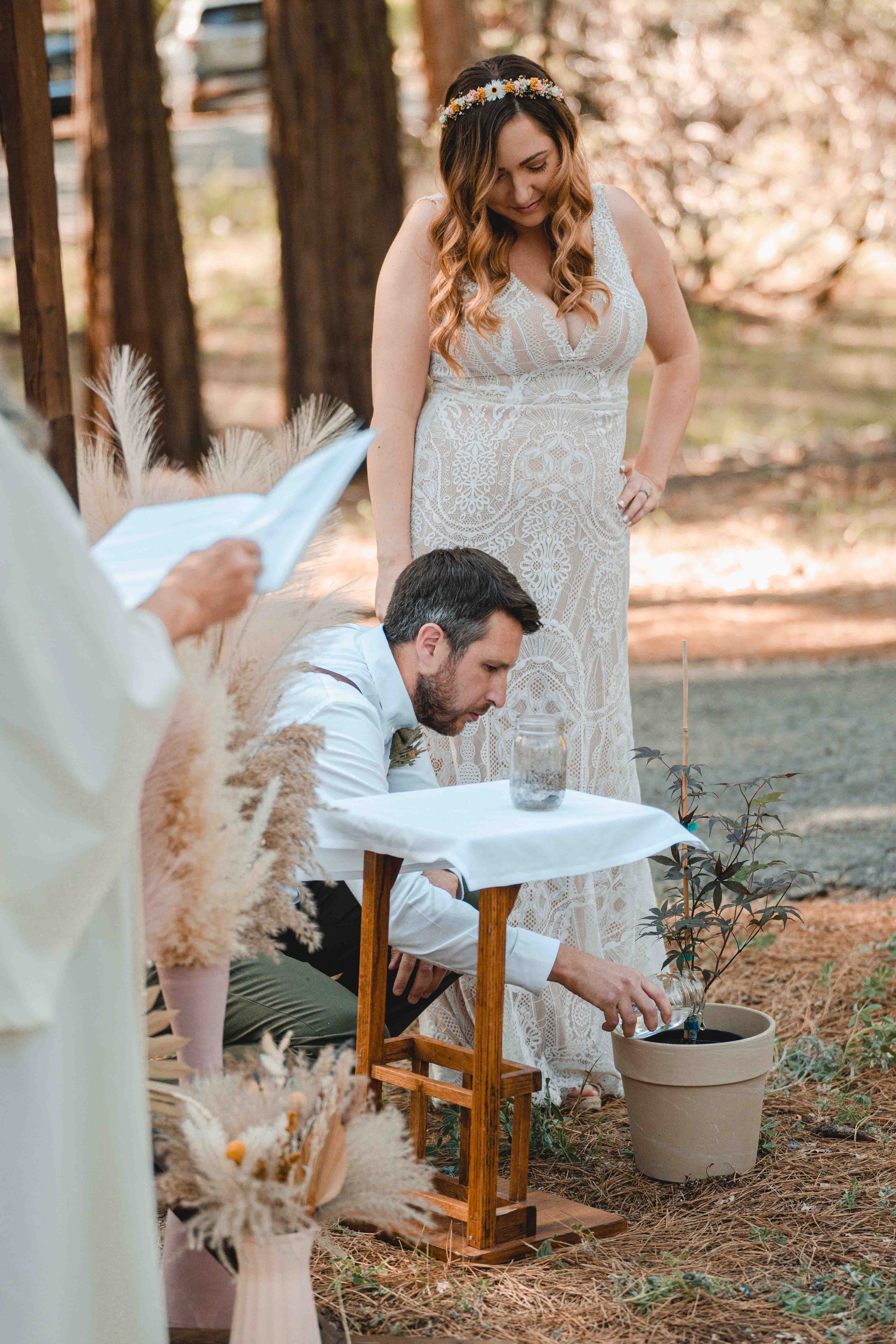 Bride and groom planting a tree during the ceremony