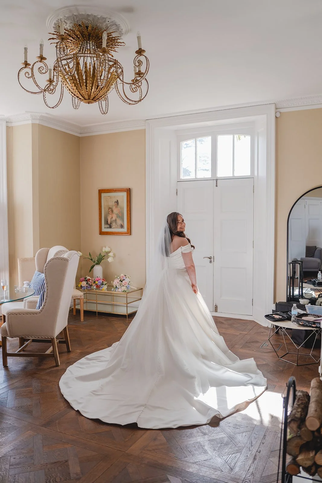 Shannon standing in her wedding dress in a bright room