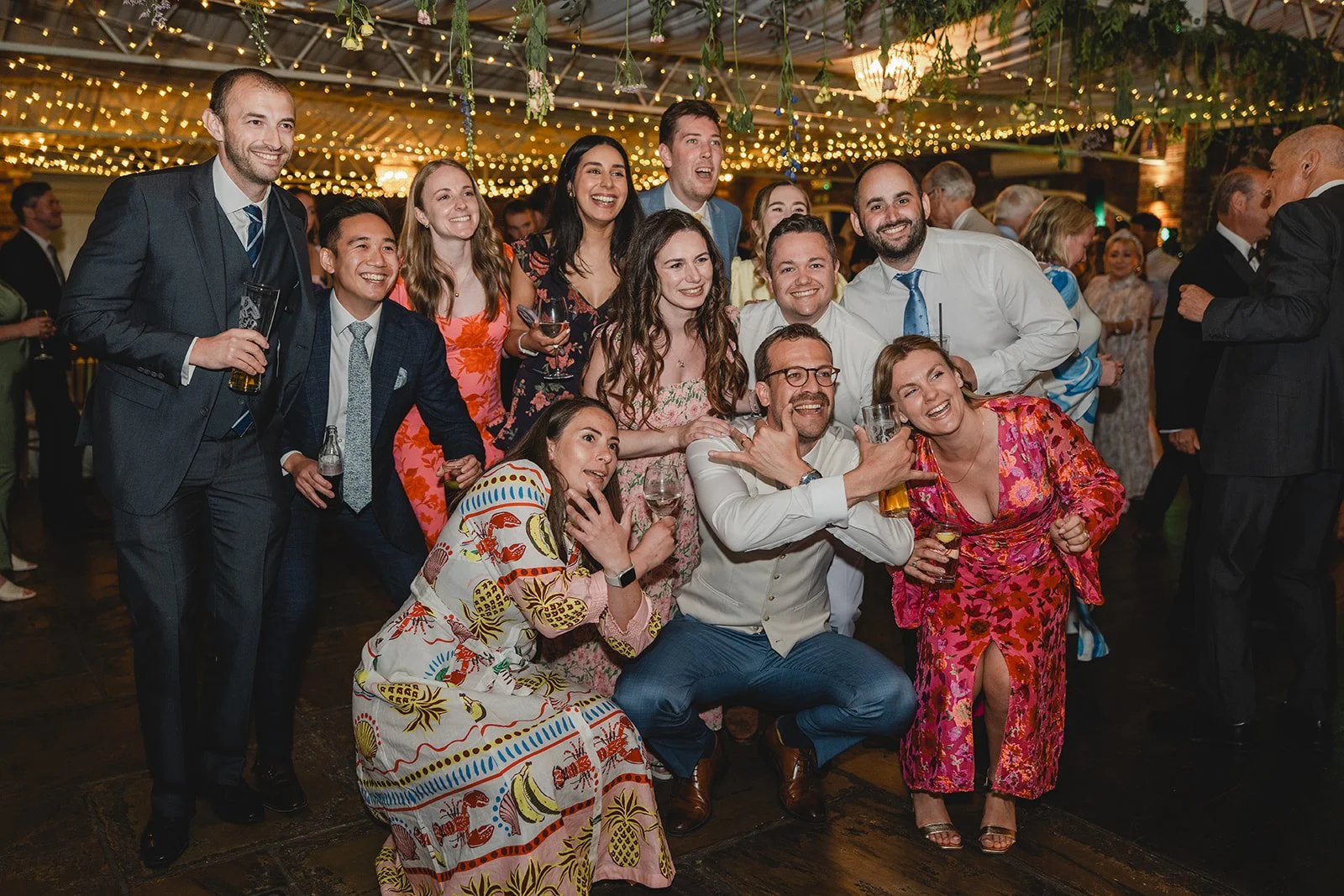 Wedding guests posing together during the evening reception
