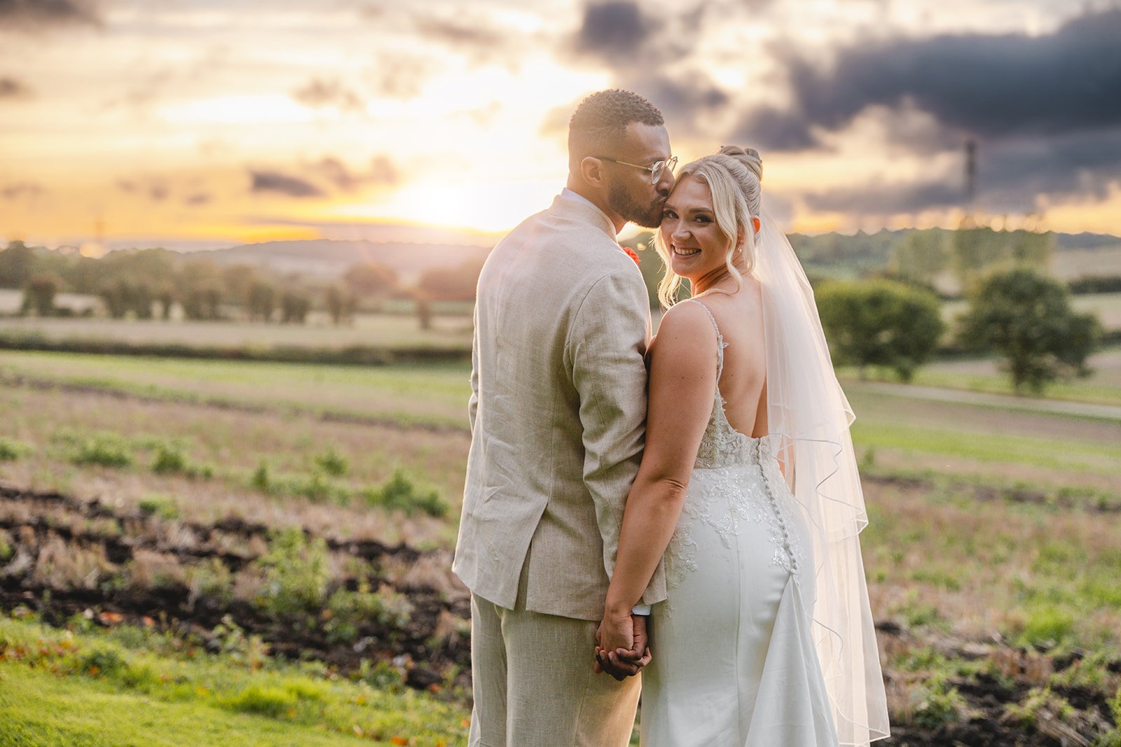 Kirsten and Josh standing together during golden hour