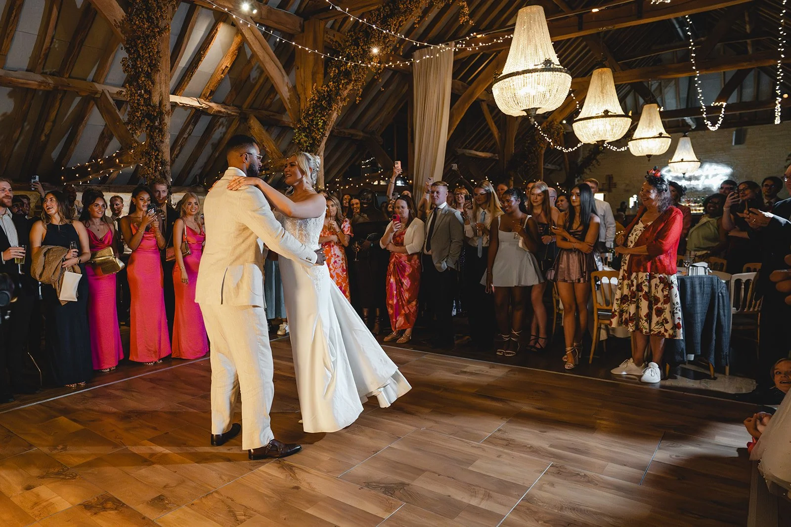 Kirsten and Josh first dance with wedding guests watching