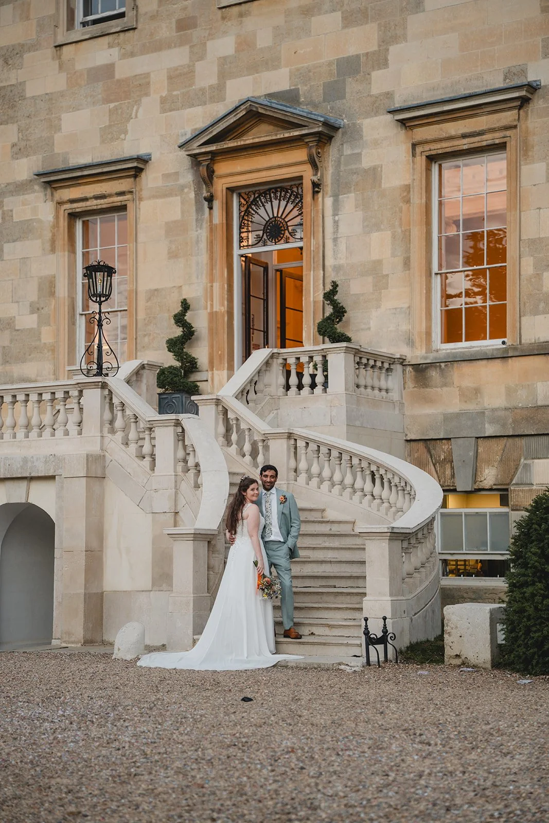 Dorothea and Peter standing on grand staircase outside wedding venue
