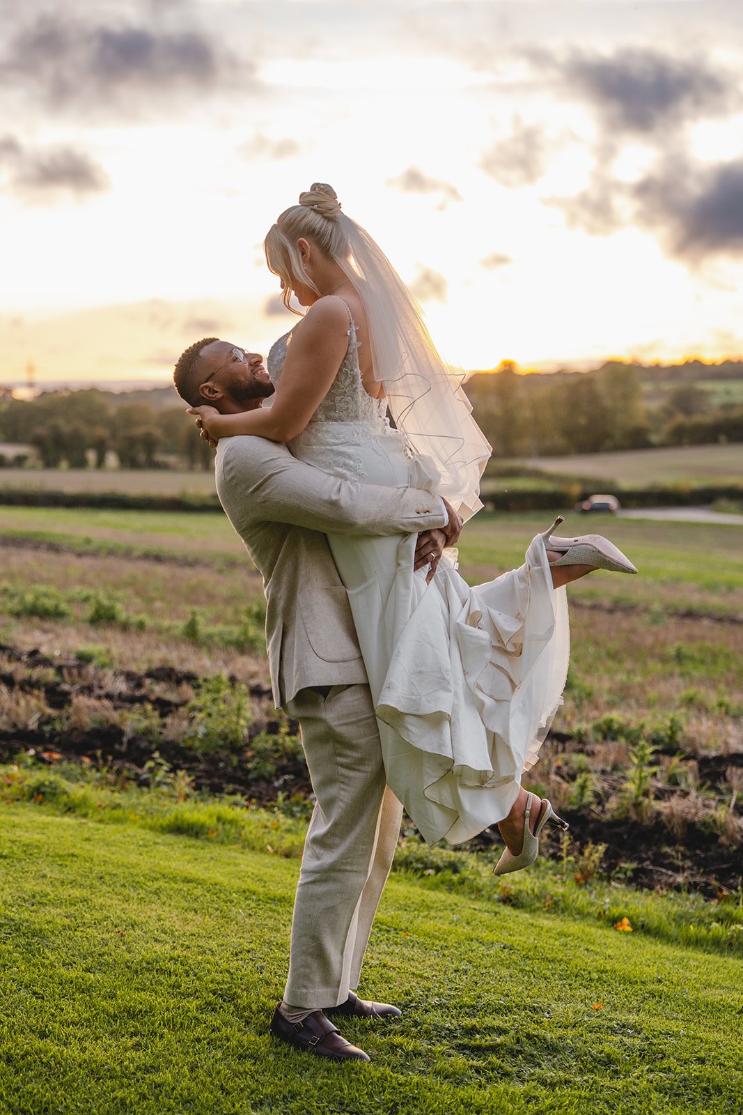 Josh lifting Kirsten during golden hour couple portraits