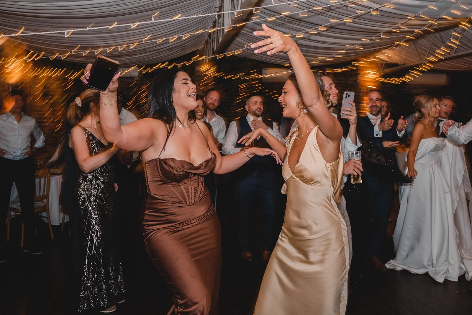 Wedding guests dancing at evening reception